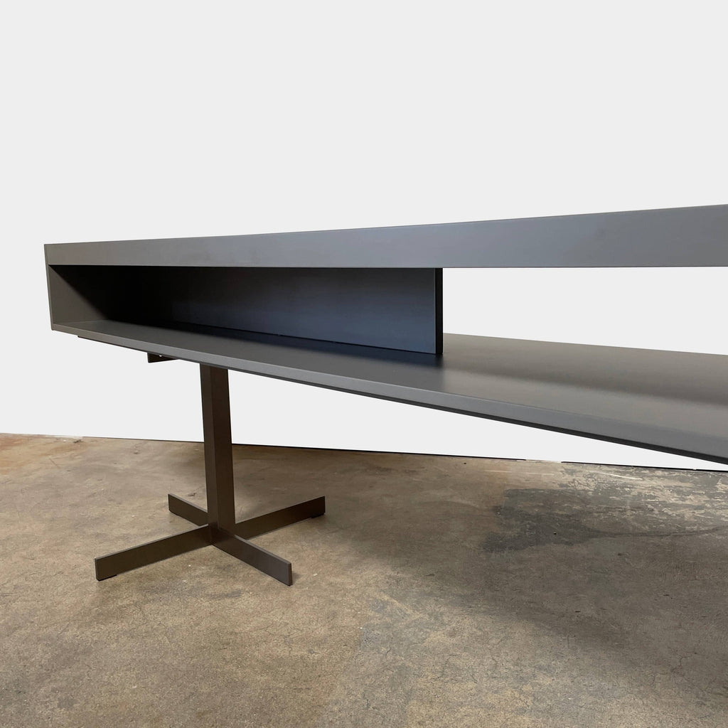 A Minotti Close Console with black legs and a glass top.