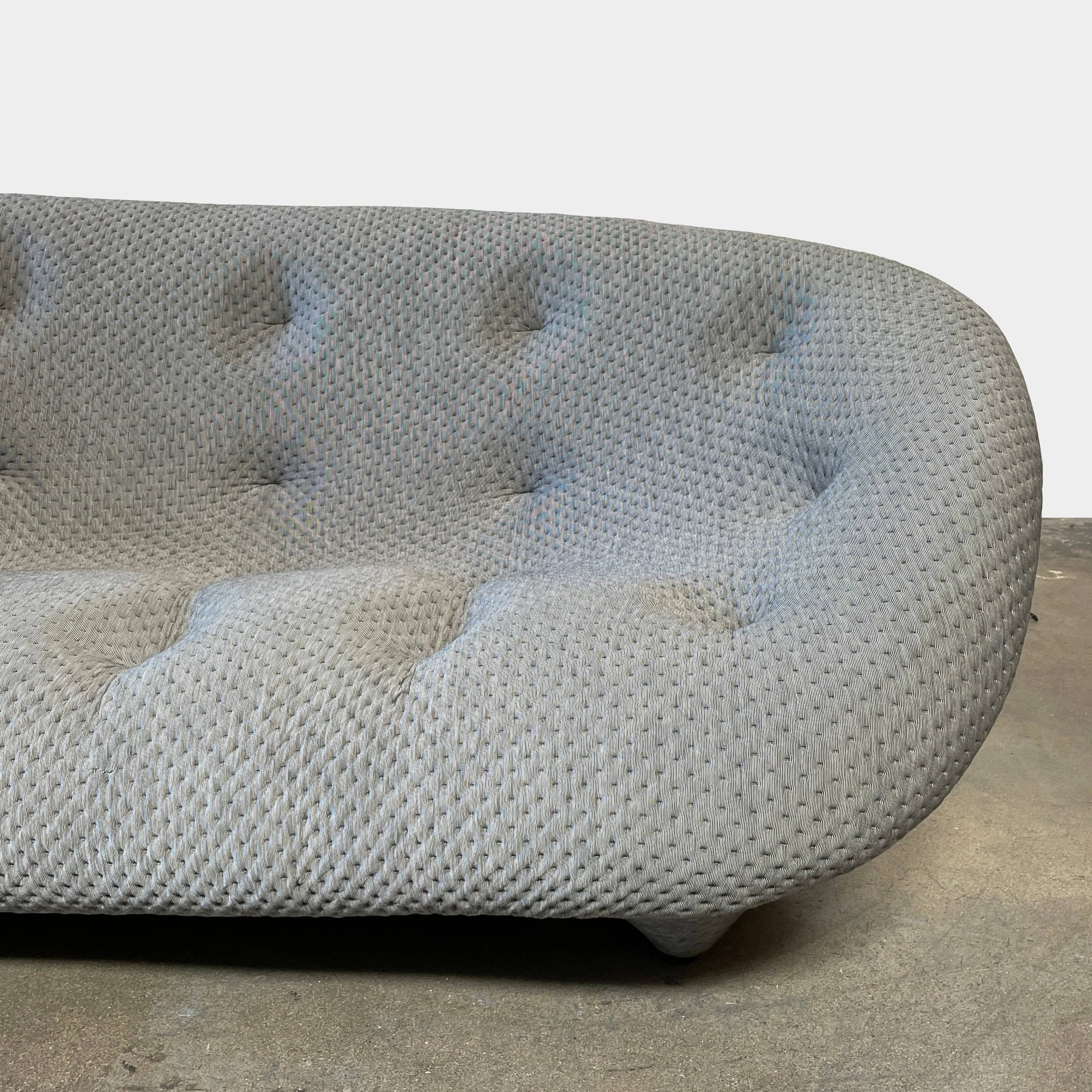 Modern tufted Ligne Roset Ploum sofa isolated against a white background.
