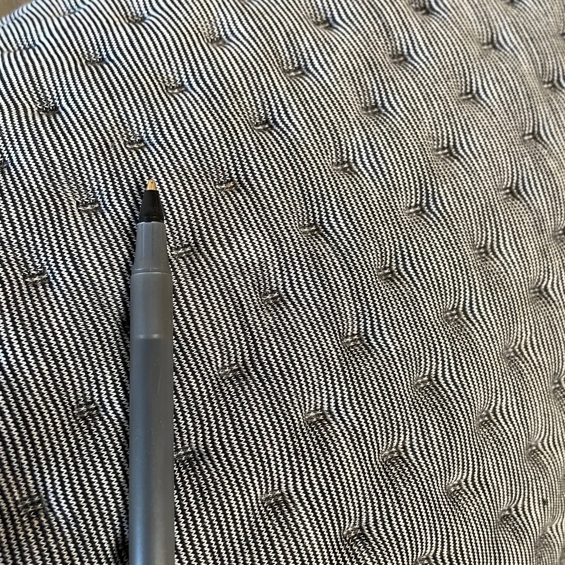 Modern tufted Ligne Roset Ploum sofa isolated against a white background.