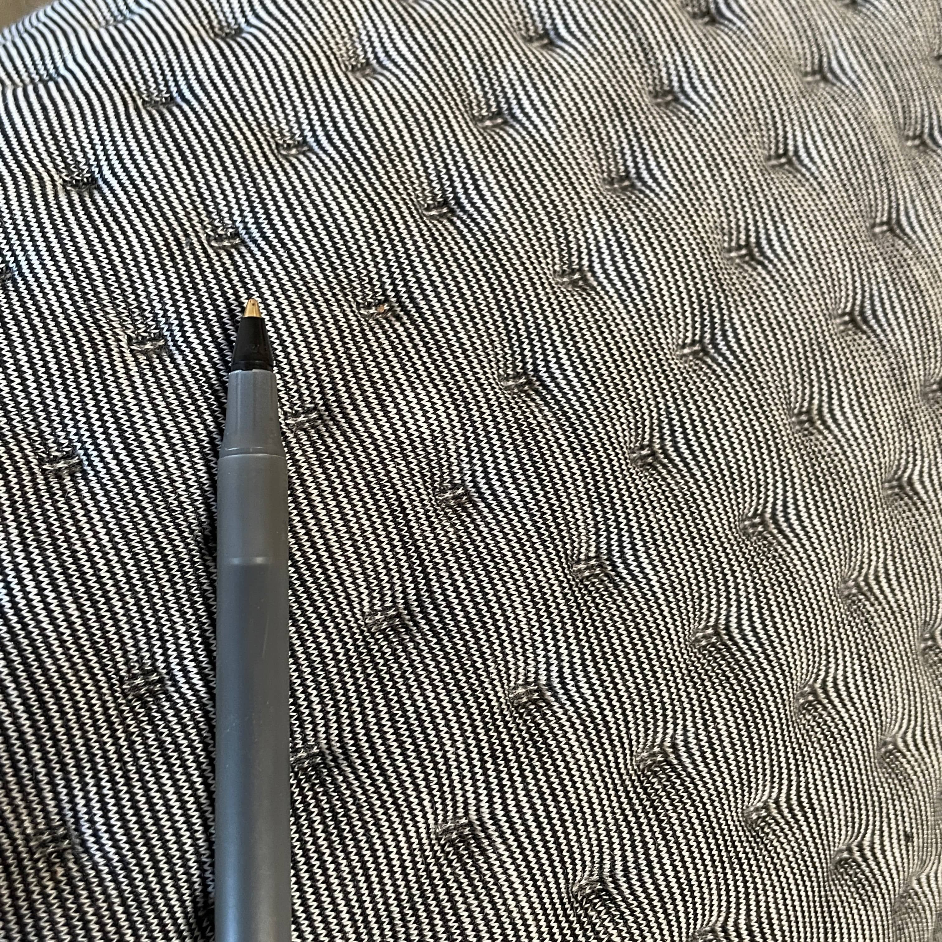 Modern tufted Ligne Roset Ploum sofa isolated against a white background.