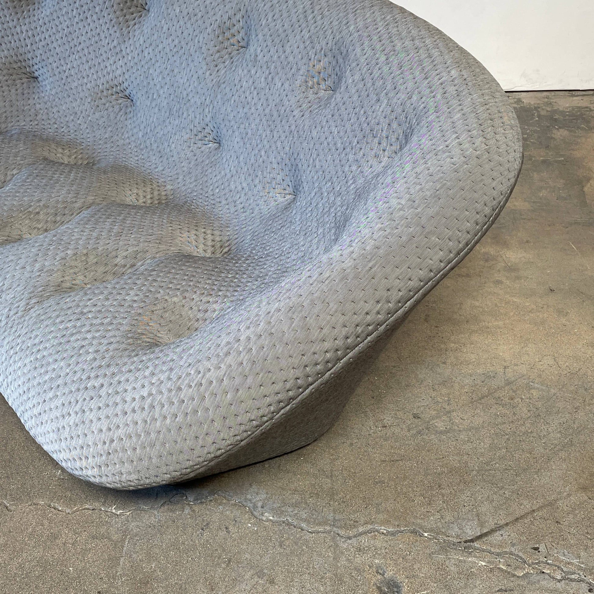 Modern tufted Ligne Roset Ploum sofa isolated against a white background.