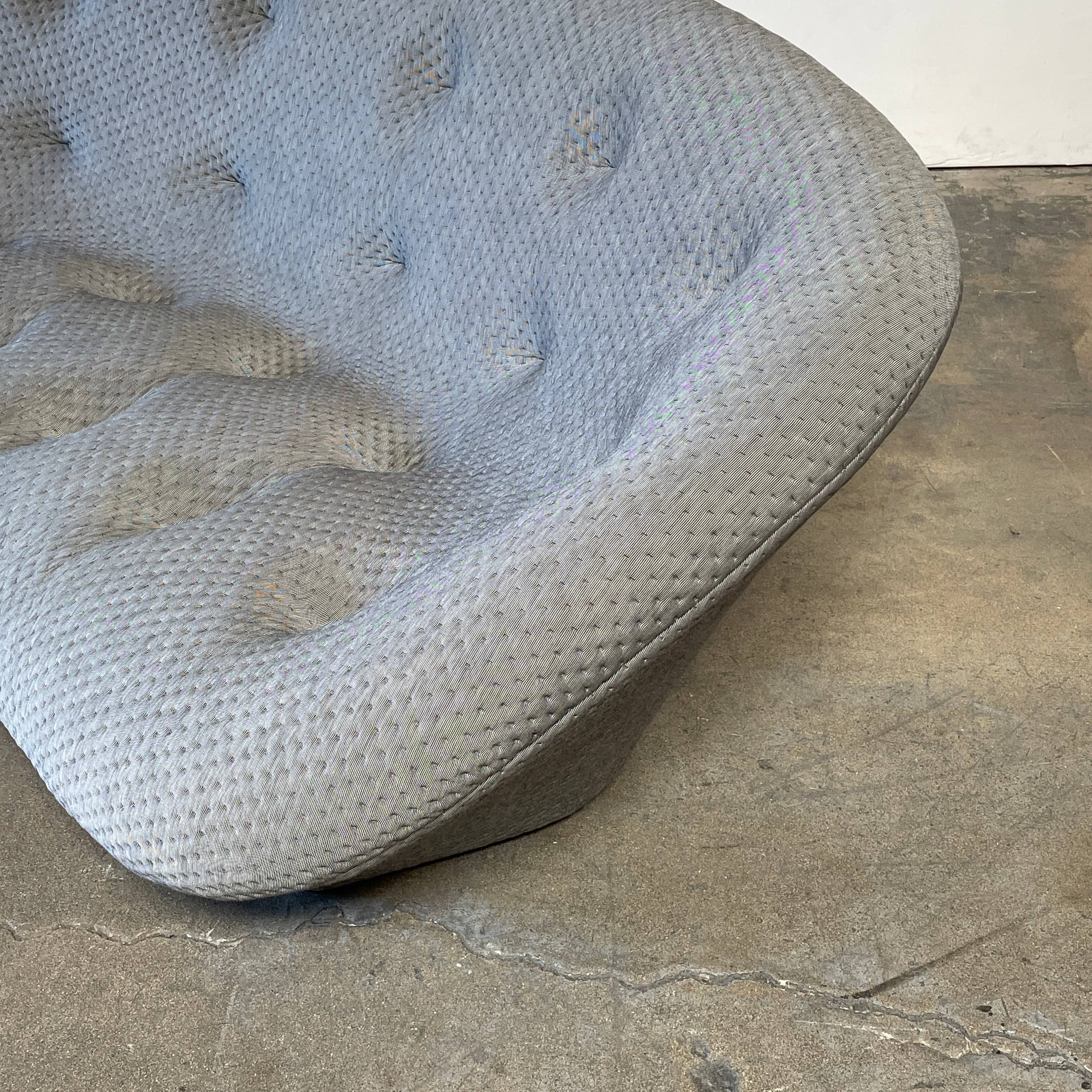 Modern tufted Ligne Roset Ploum sofa isolated against a white background.