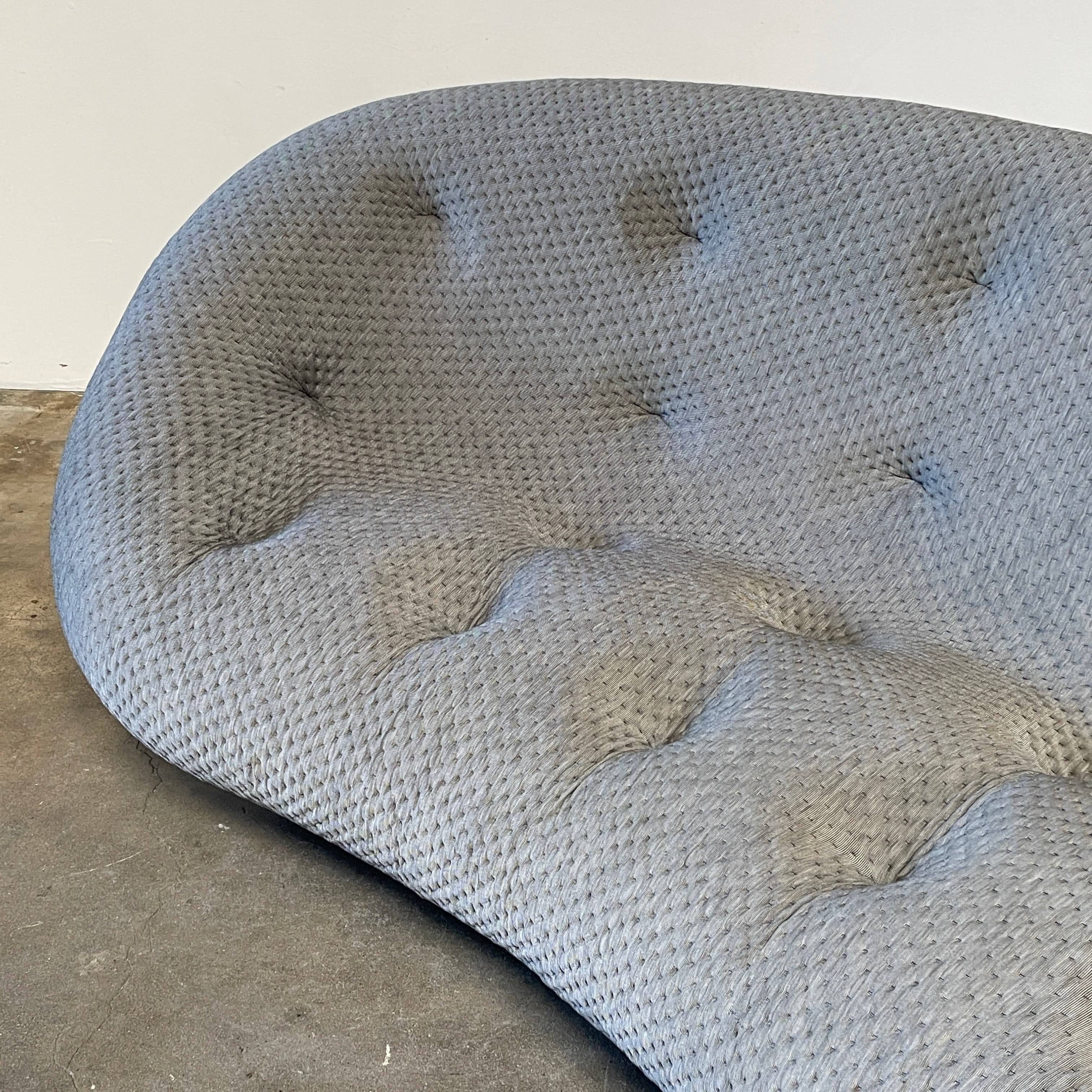 Modern tufted Ligne Roset Ploum sofa isolated against a white background.