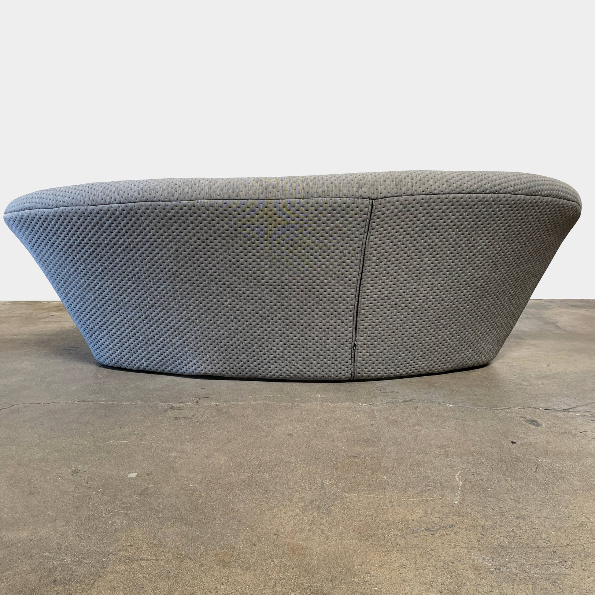 Modern tufted Ligne Roset Ploum sofa isolated against a white background.