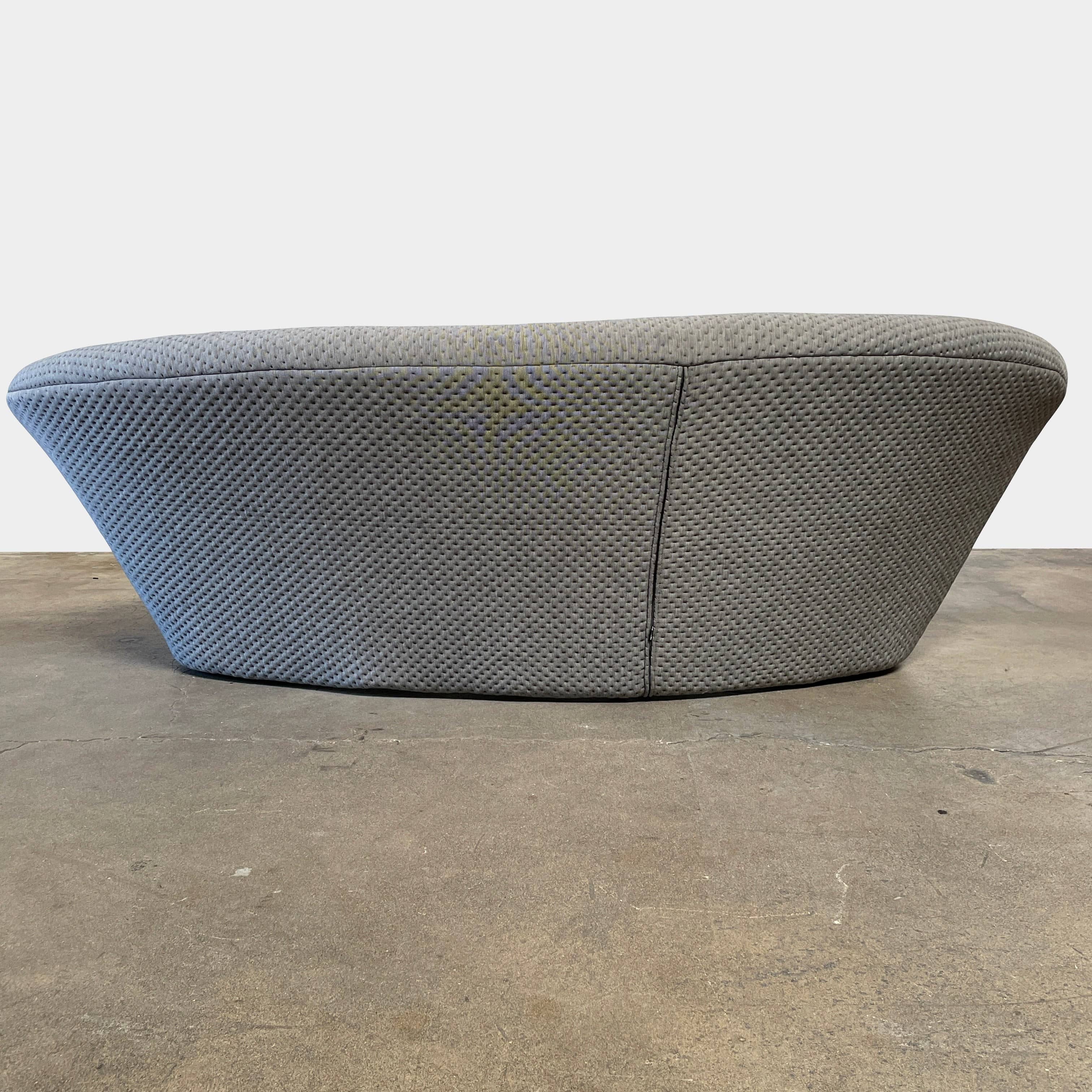 Modern tufted Ligne Roset Ploum sofa isolated against a white background.