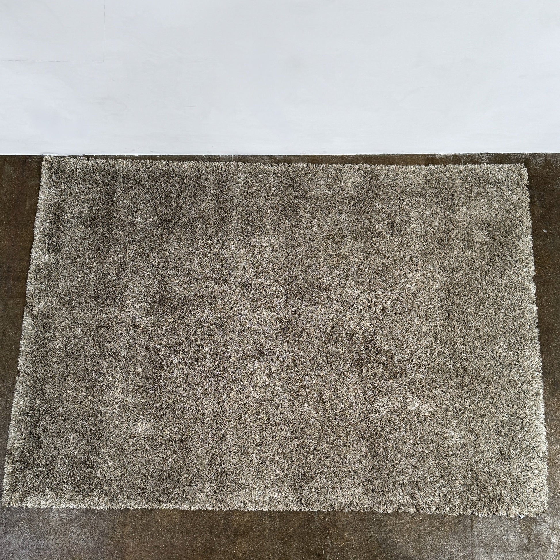 A close-up of the corner of a Kasthall Gray Fogg 2 Shag Rug (7 x 10) is shown on a white background.