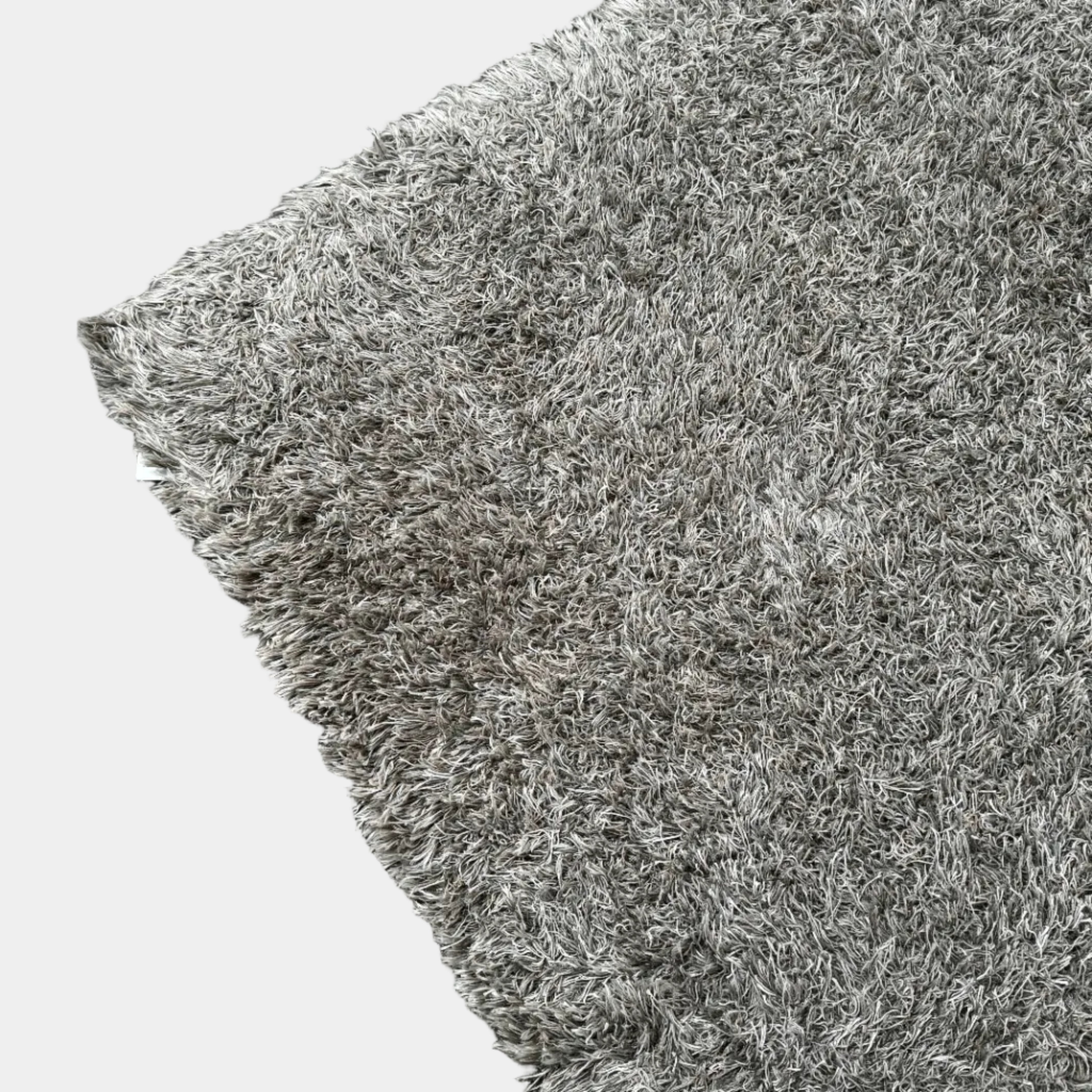 A close-up of the corner of a Kasthall Gray Fogg 2 Shag Rug (7 x 10) is shown on a white background.