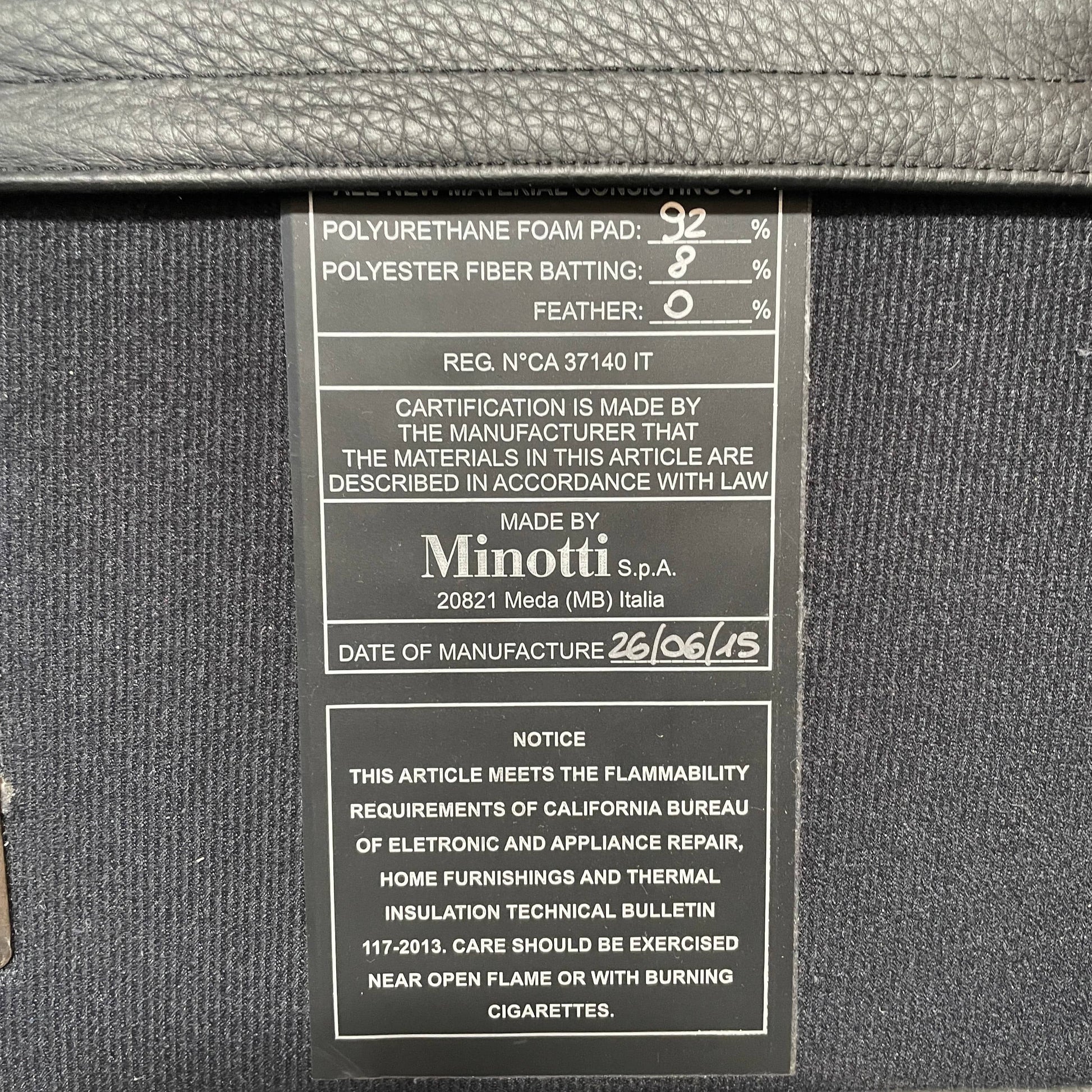 A Minotti Bartlett Cal King Bed with a wooden slatted base.