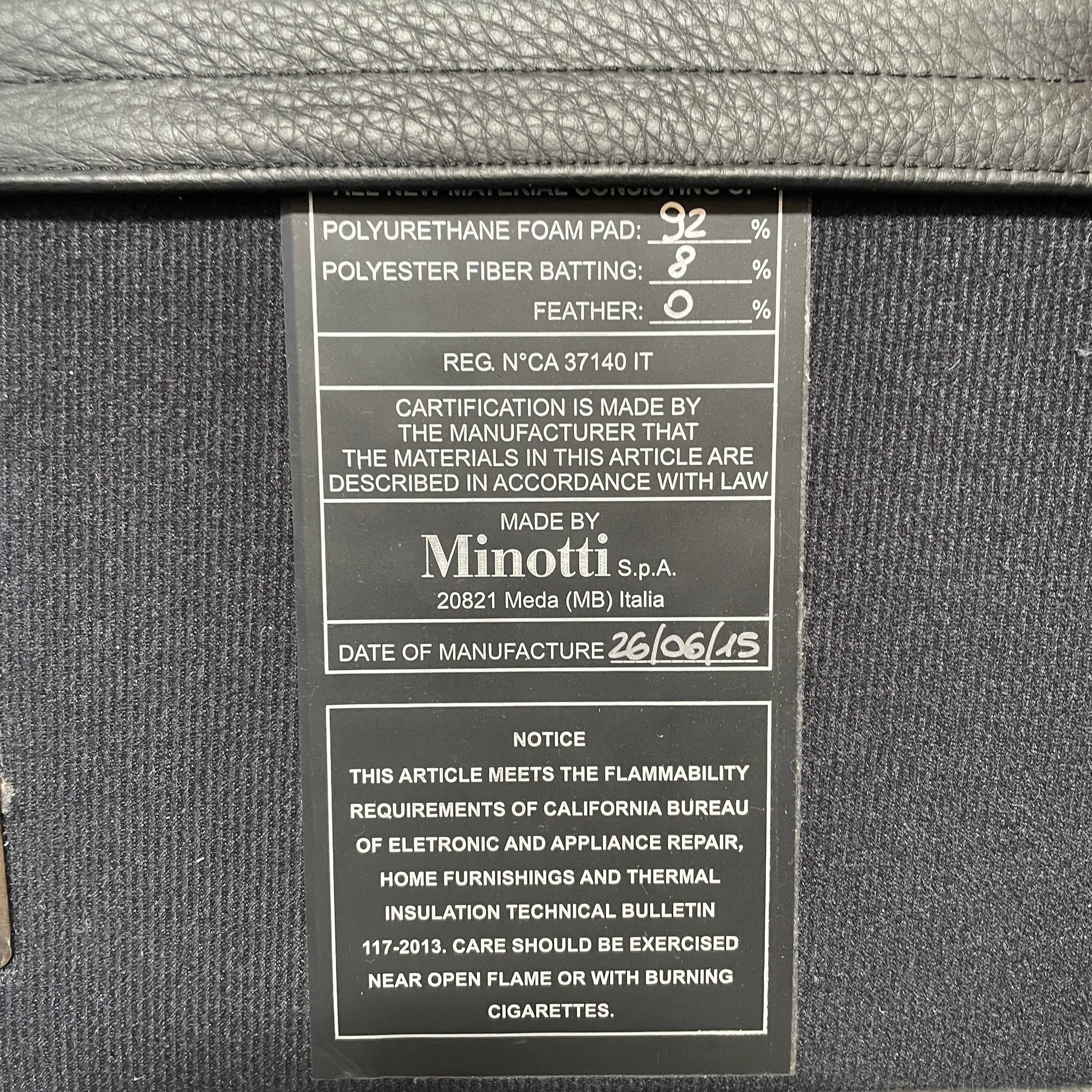 A Minotti Bartlett Cal King Bed with a wooden slatted base.