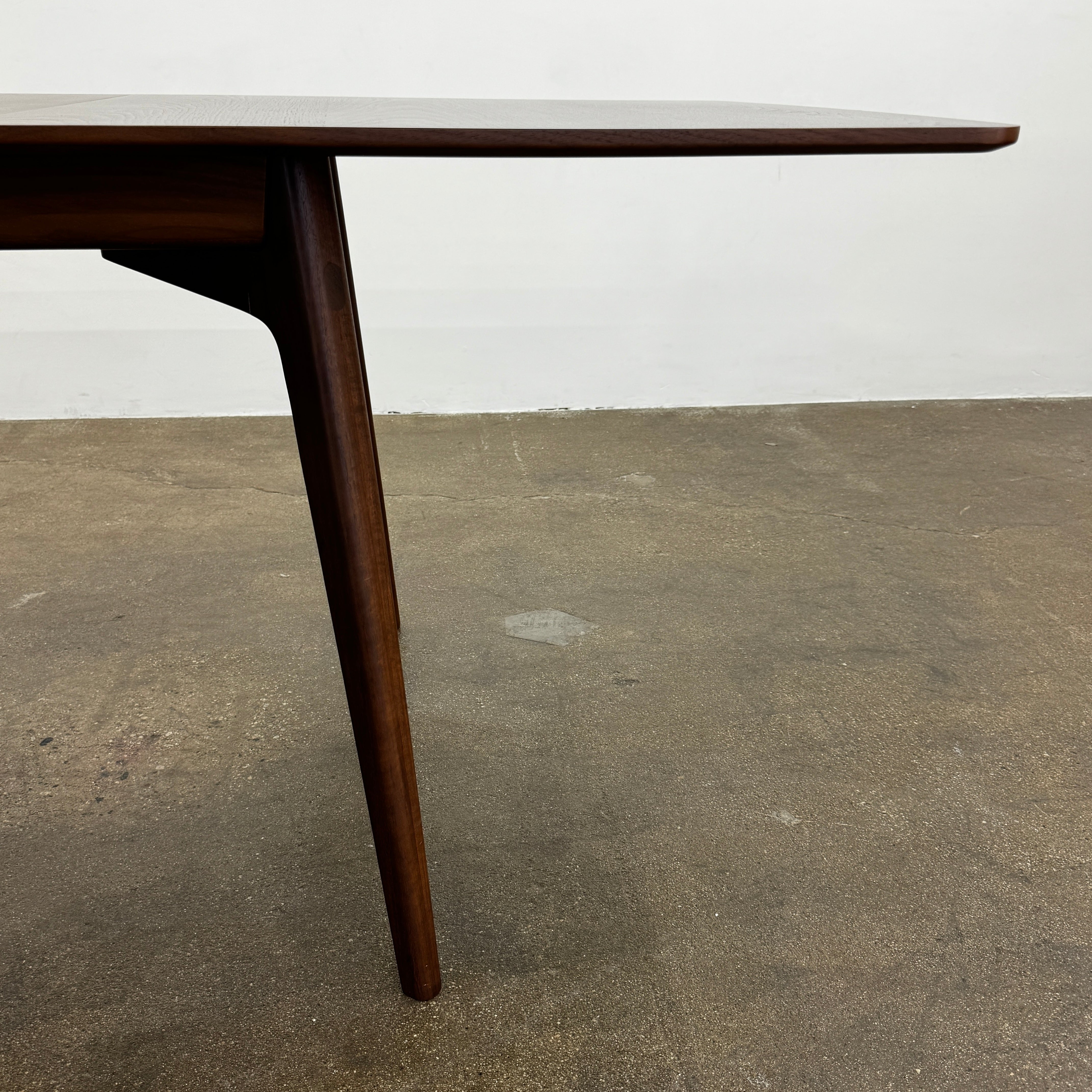 The Case Design Dulwich Extension Table by Case is an elegant rectangular walnut dining table with four legs and a smooth, flat surface, viewed from the front against a plain white background—ideal for modern dining spaces.