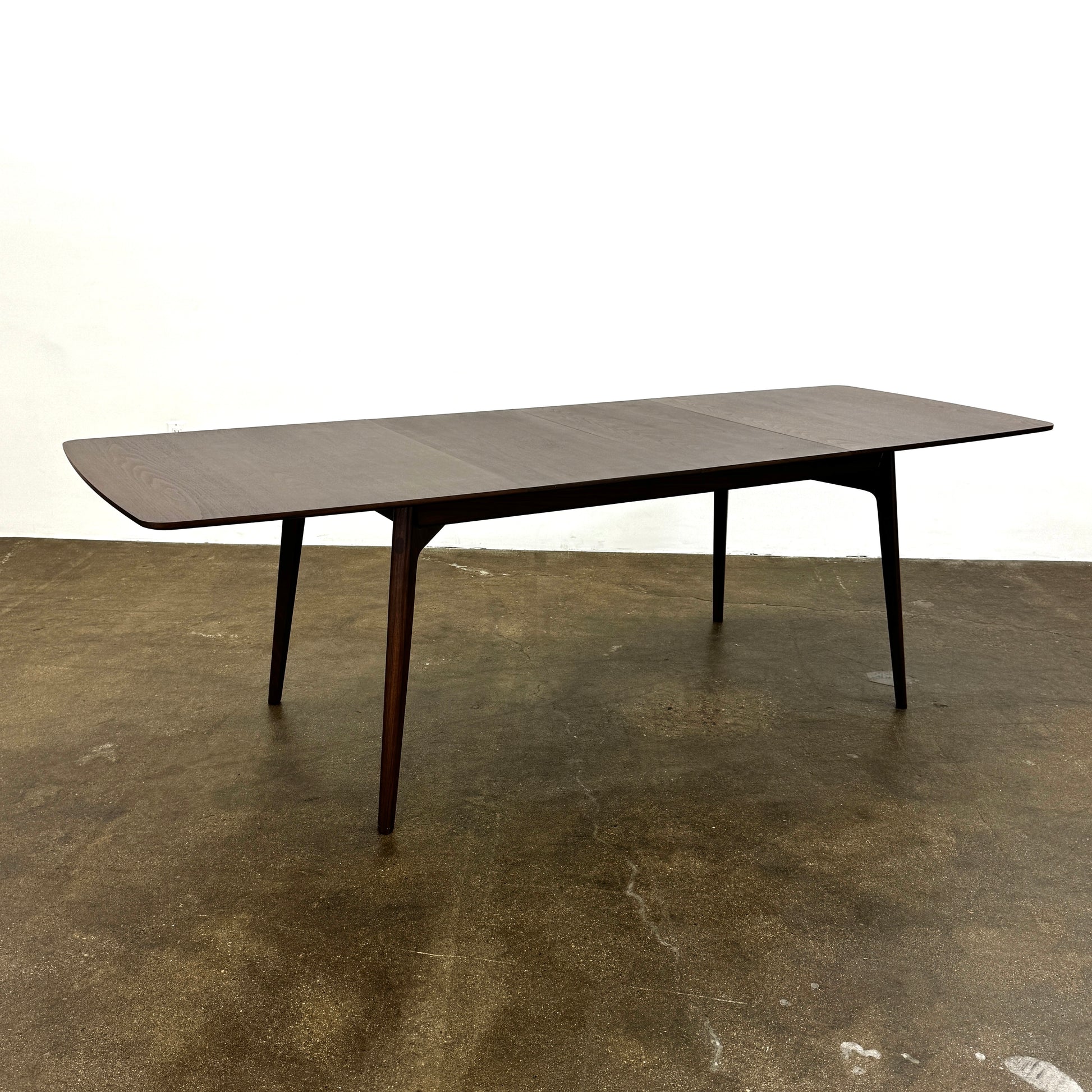 The Case Design Dulwich Extension Table by Case is an elegant rectangular walnut dining table with four legs and a smooth, flat surface, viewed from the front against a plain white background—ideal for modern dining spaces.