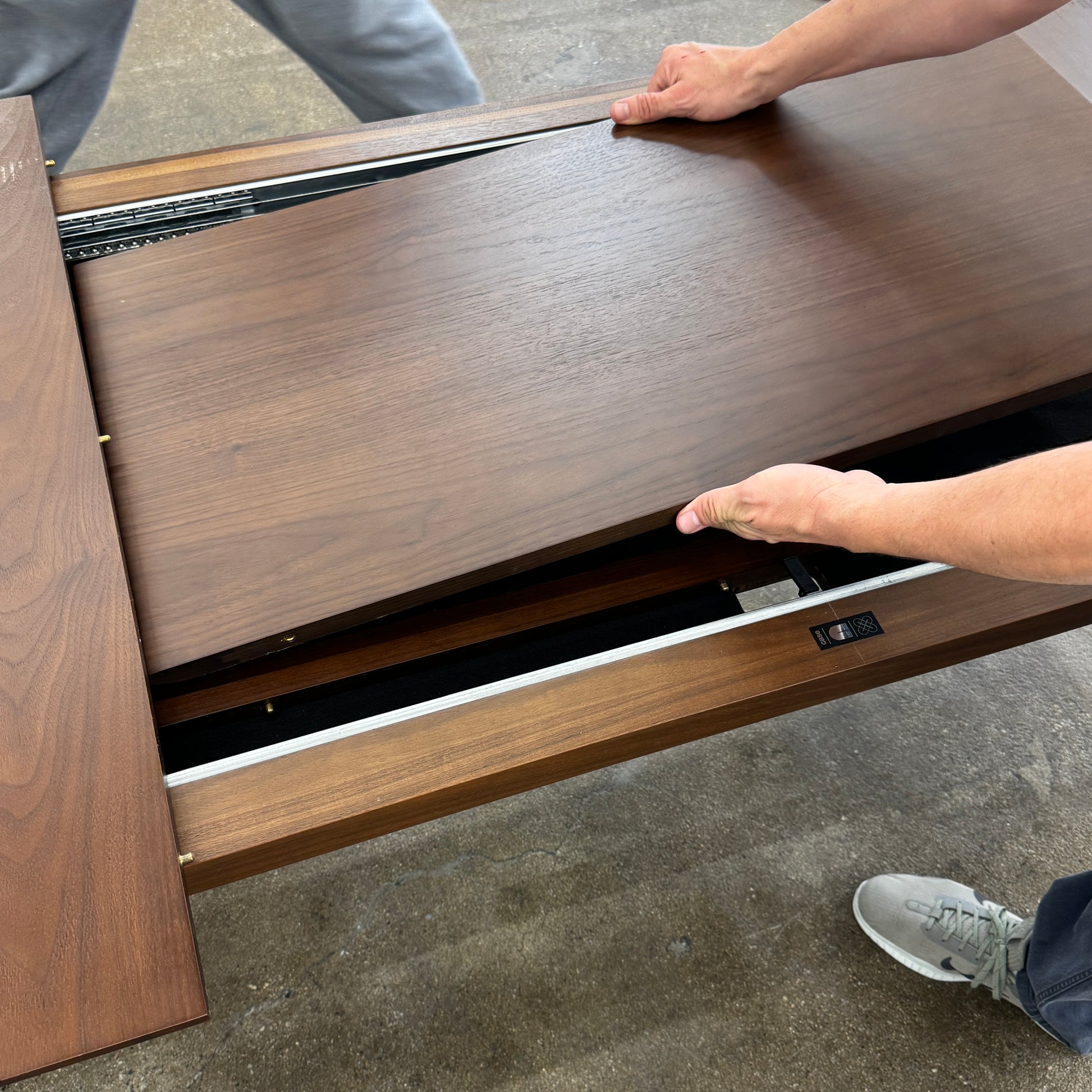 The Case Design Dulwich Extension Table by Case is an elegant rectangular walnut dining table with four legs and a smooth, flat surface, viewed from the front against a plain white background—ideal for modern dining spaces.