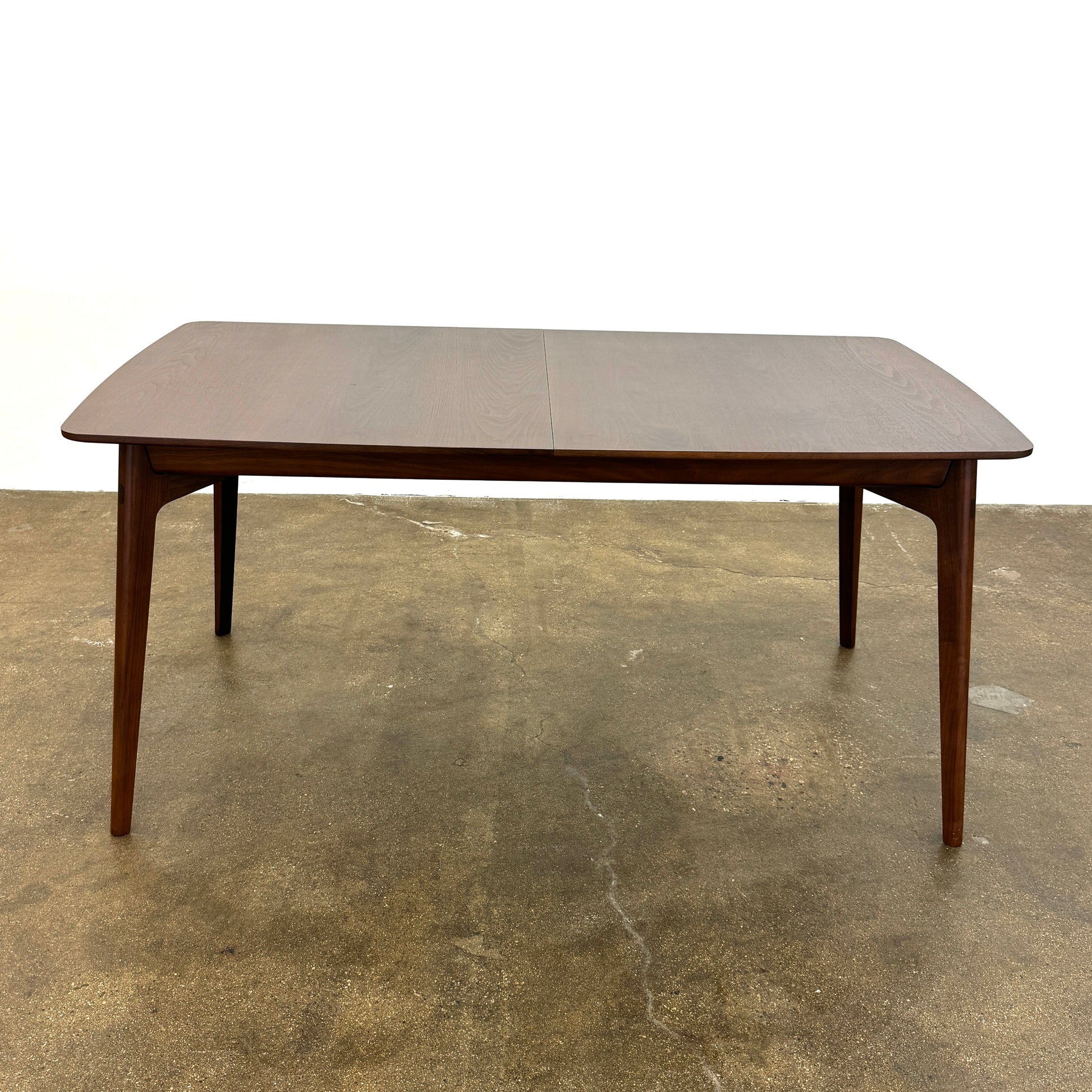 The Case Design Dulwich Extension Table by Case is an elegant rectangular walnut dining table with four legs and a smooth, flat surface, viewed from the front against a plain white background—ideal for modern dining spaces.