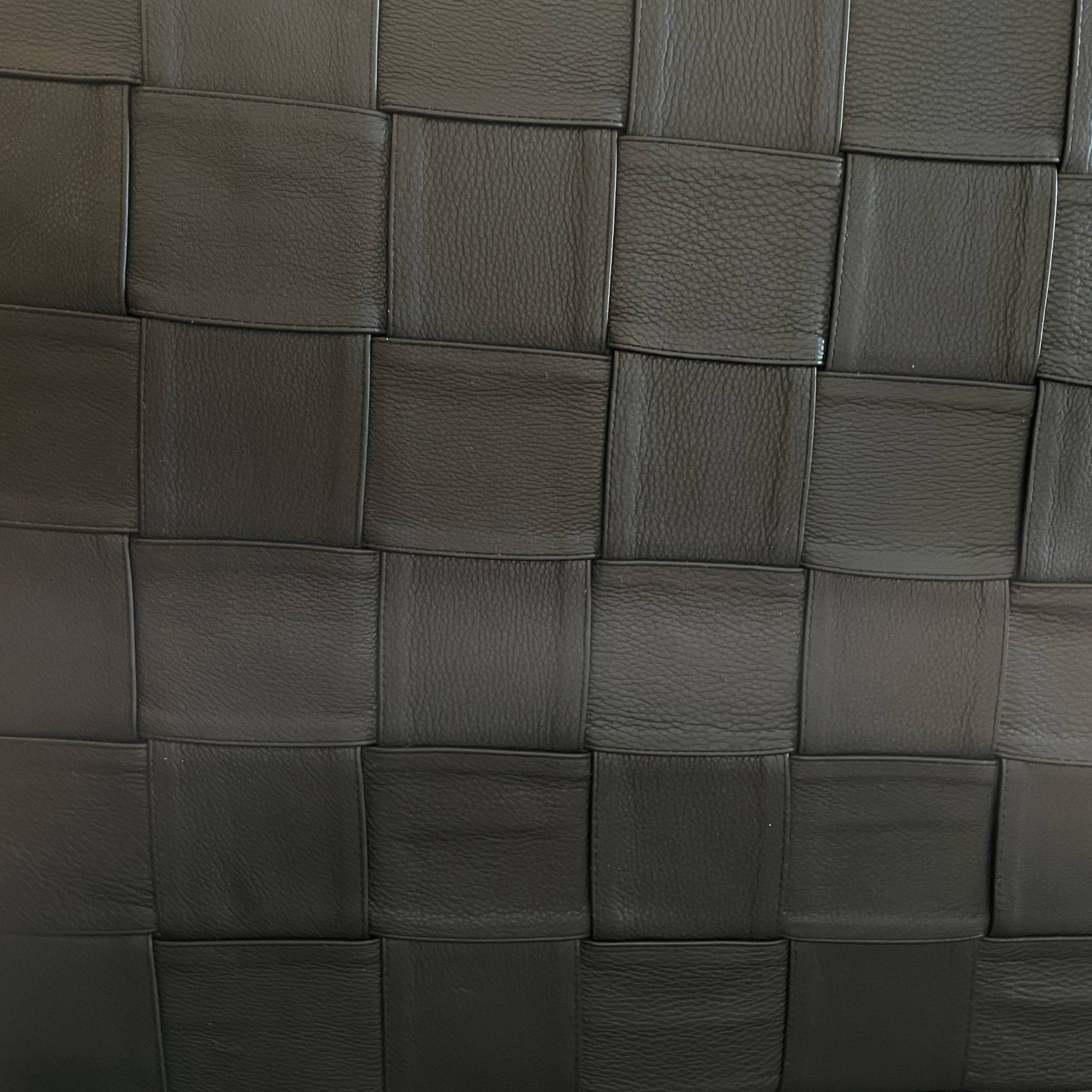 A Minotti Bartlett Cal King Bed with a wooden slatted base.