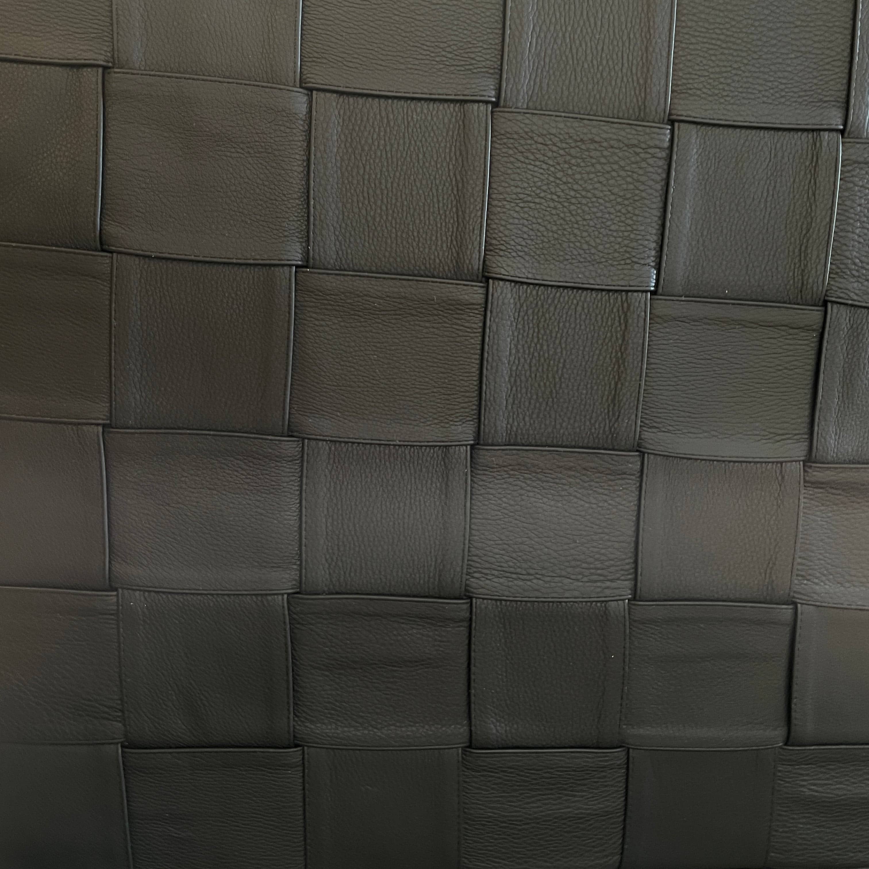 A Minotti Bartlett Cal King Bed with a wooden slatted base.