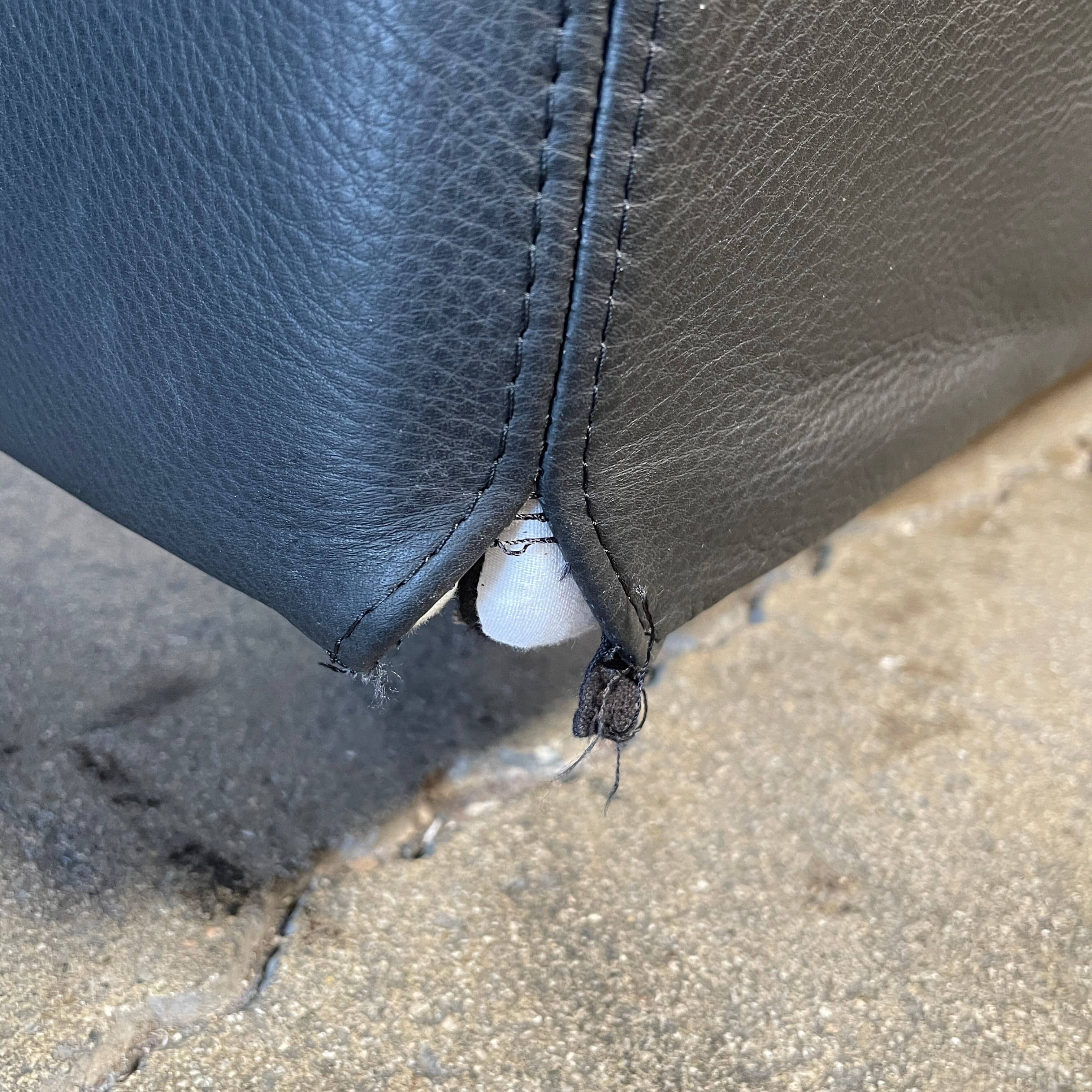 A Minotti Bartlett Cal King Bed with a wooden slatted base.