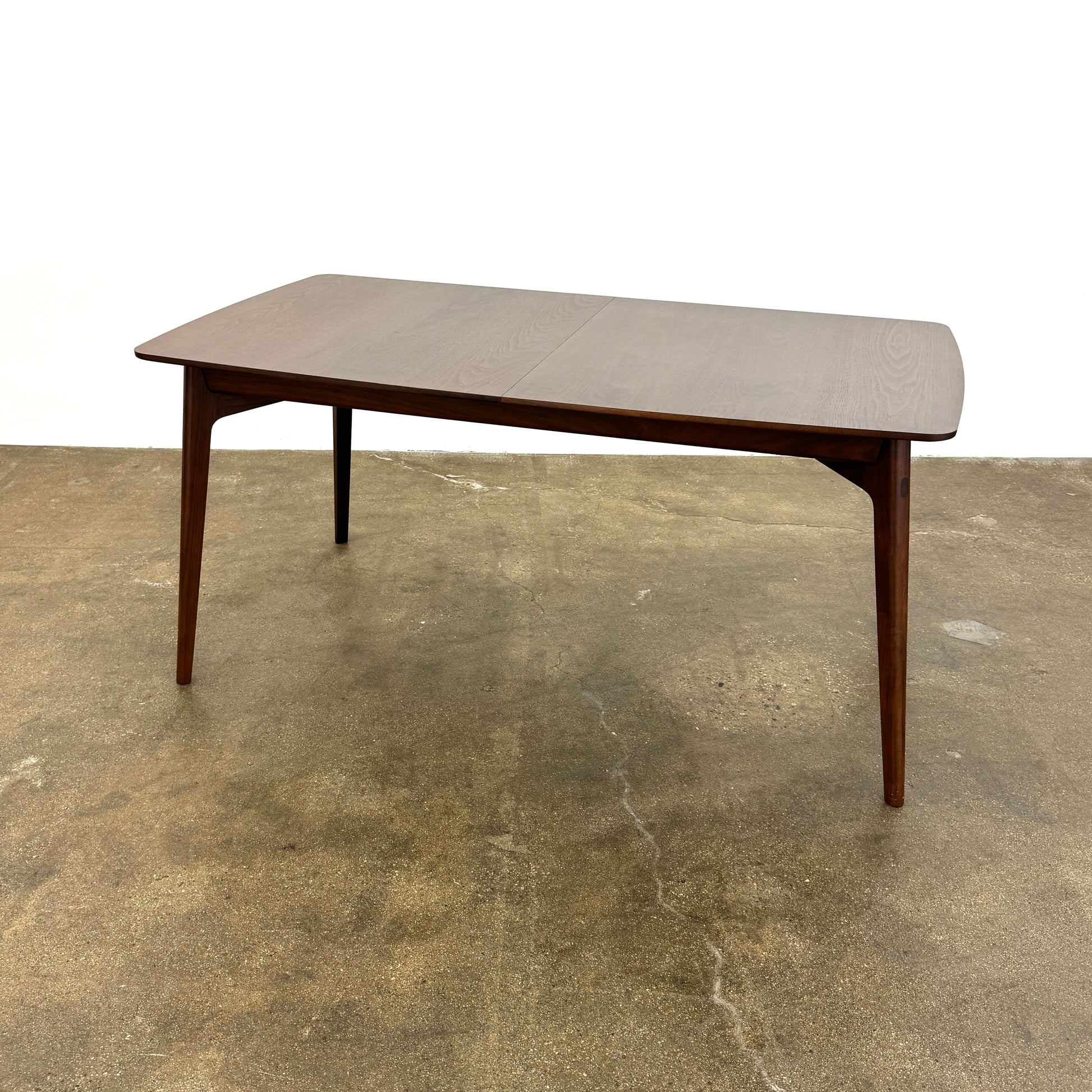 The Case Design Dulwich Extension Table by Case is an elegant rectangular walnut dining table with four legs and a smooth, flat surface, viewed from the front against a plain white background—ideal for modern dining spaces.