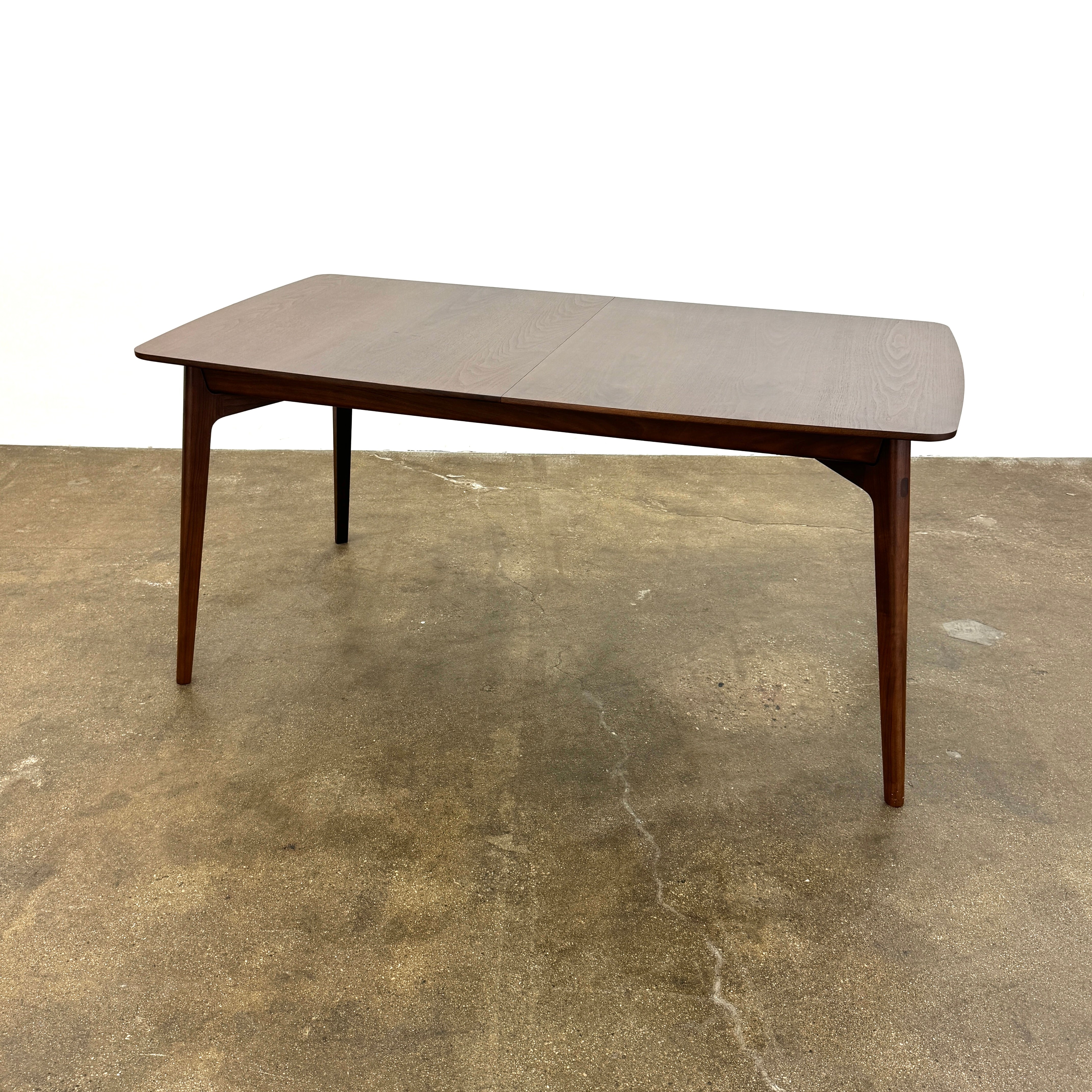 The Case Design Dulwich Extension Table by Case is an elegant rectangular walnut dining table with four legs and a smooth, flat surface, viewed from the front against a plain white background—ideal for modern dining spaces.