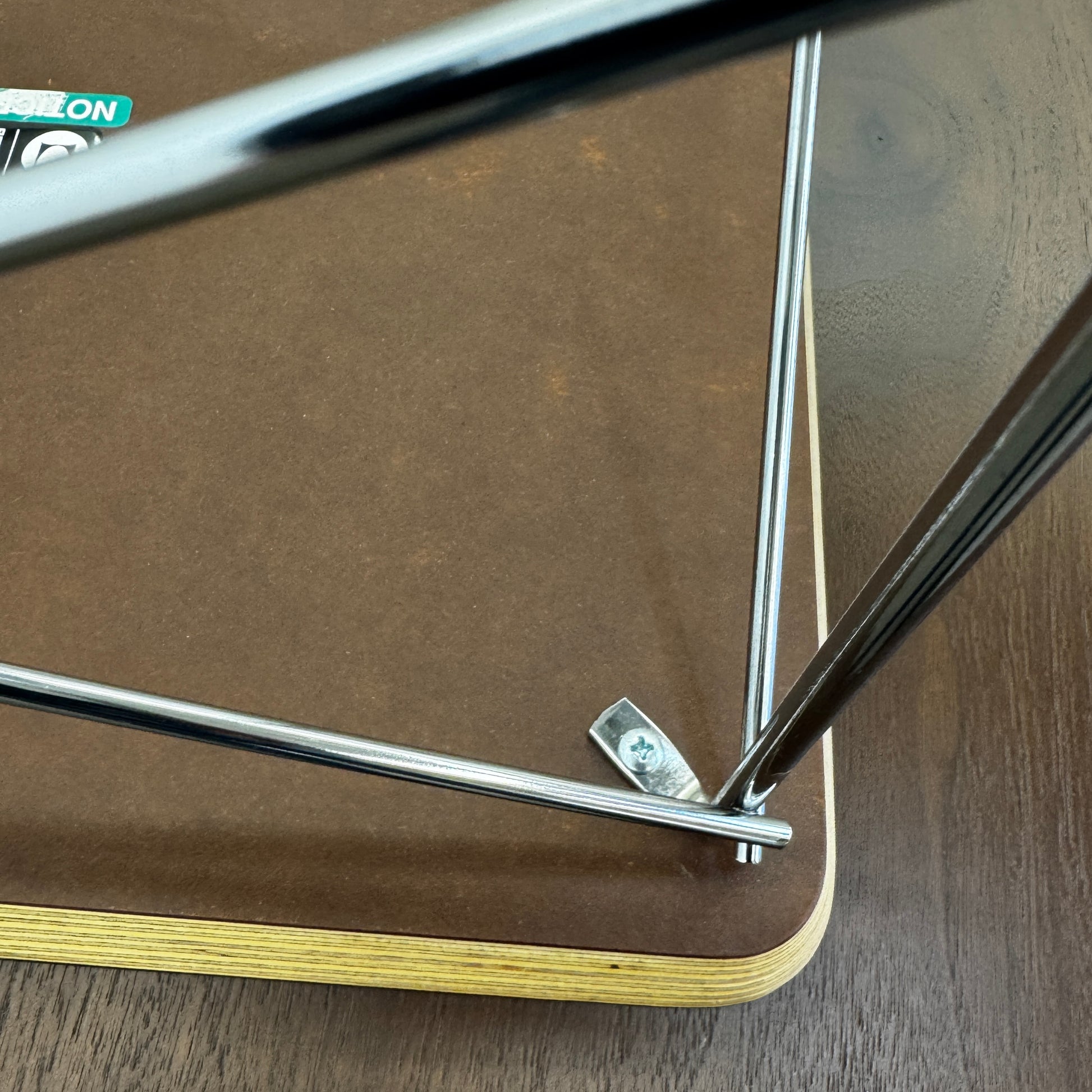 Two Herman Miller Eames Wire Base Low Tables are set side by side on a light wood floor in a bright, minimalist room, showcasing the iconic design and craftsmanship of Herman Miller.