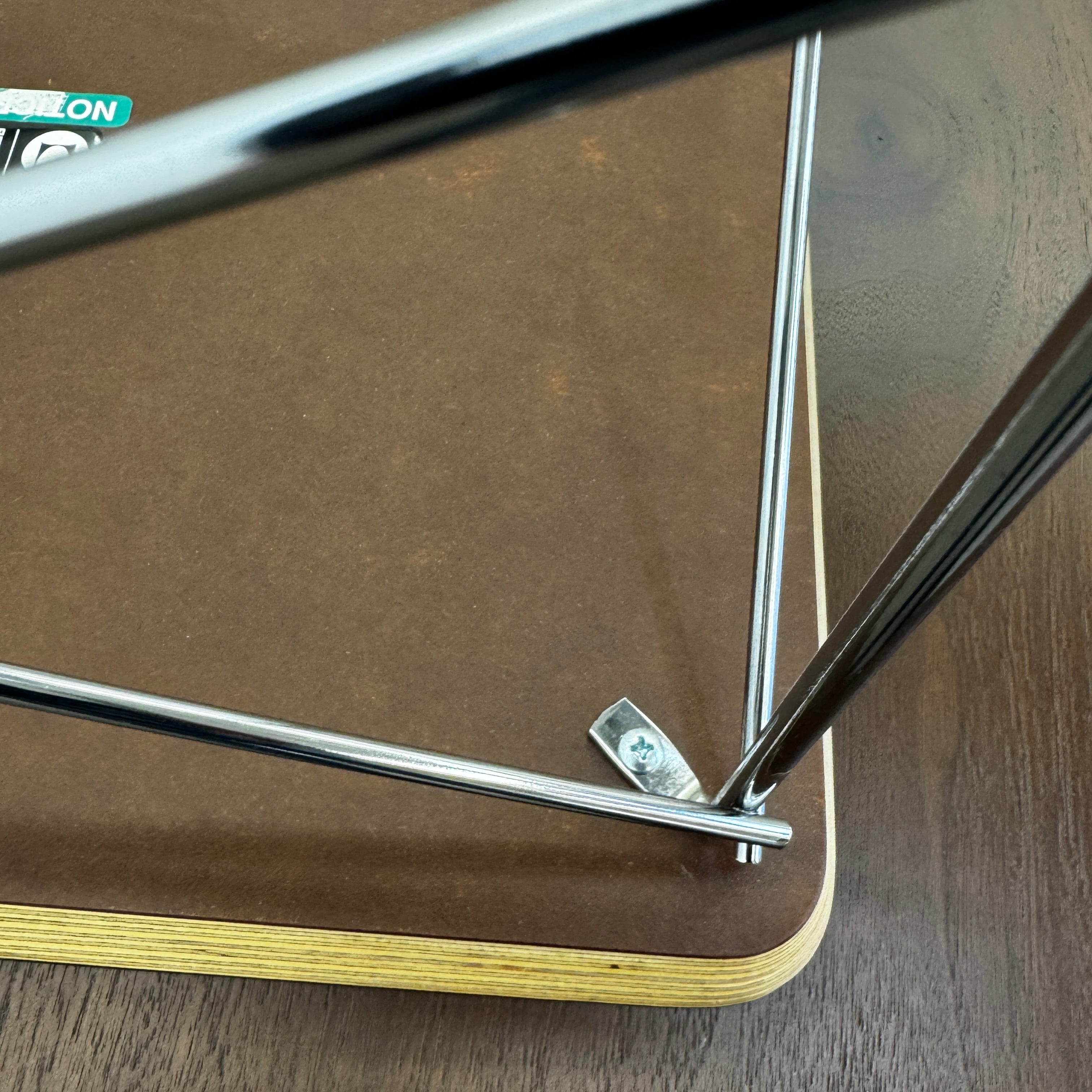 Two Herman Miller Eames Wire Base Low Tables are set side by side on a light wood floor in a bright, minimalist room, showcasing the iconic design and craftsmanship of Herman Miller.