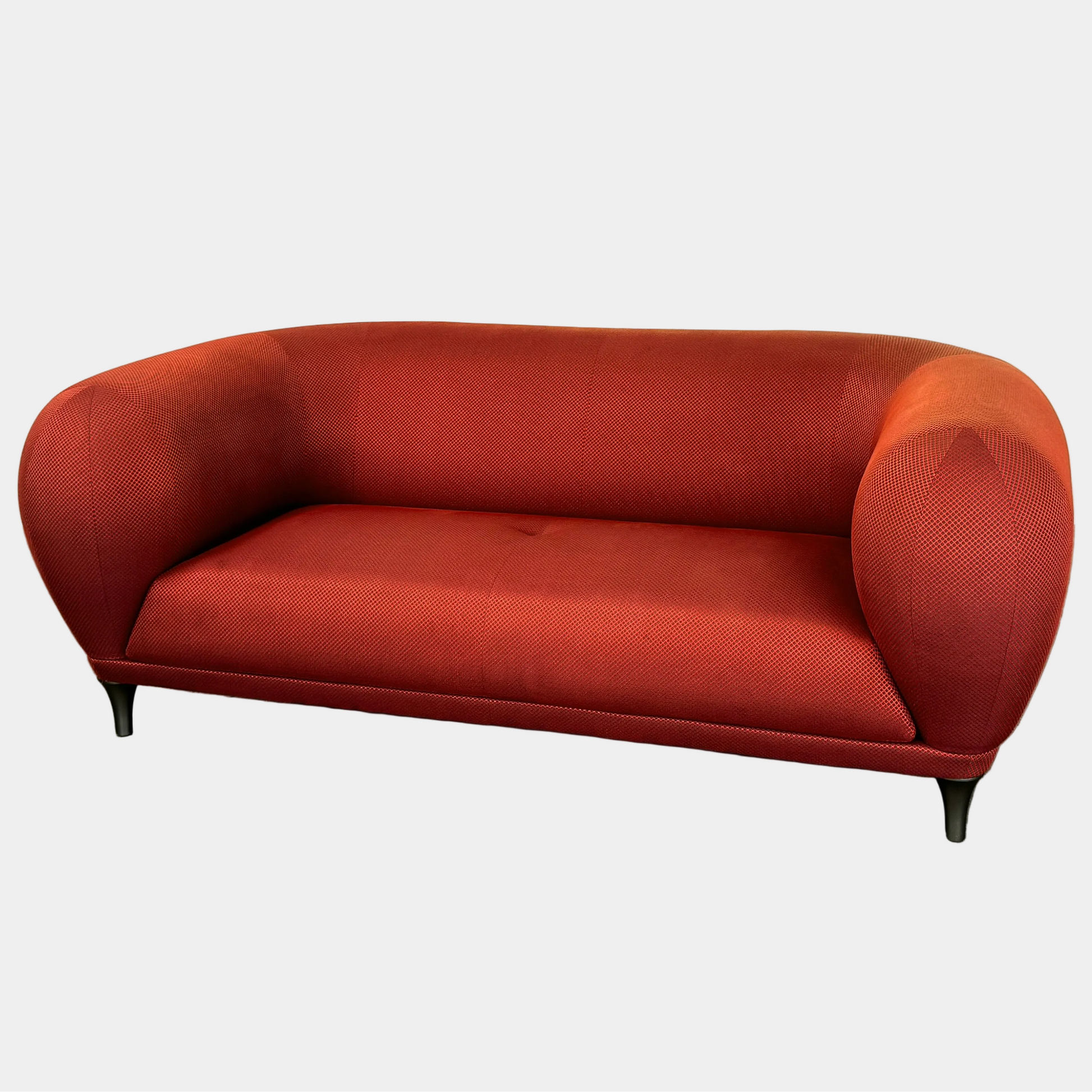 The Roche Bobois Montgolfiere Love seat is a modern, red 2-seat sofa with curved arms and dark wooden legs by Roche Bobois, shown against a plain background.