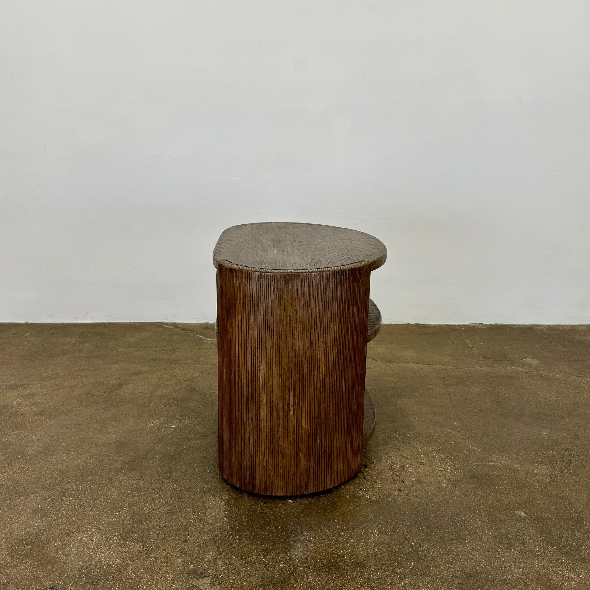 The Palachek Leonardo Side Table, Large, by Palachek features artisan craftsmanship, a dark brown finish, two shelves, and an open minimalist design that suits any contemporary decor against a plain white background.