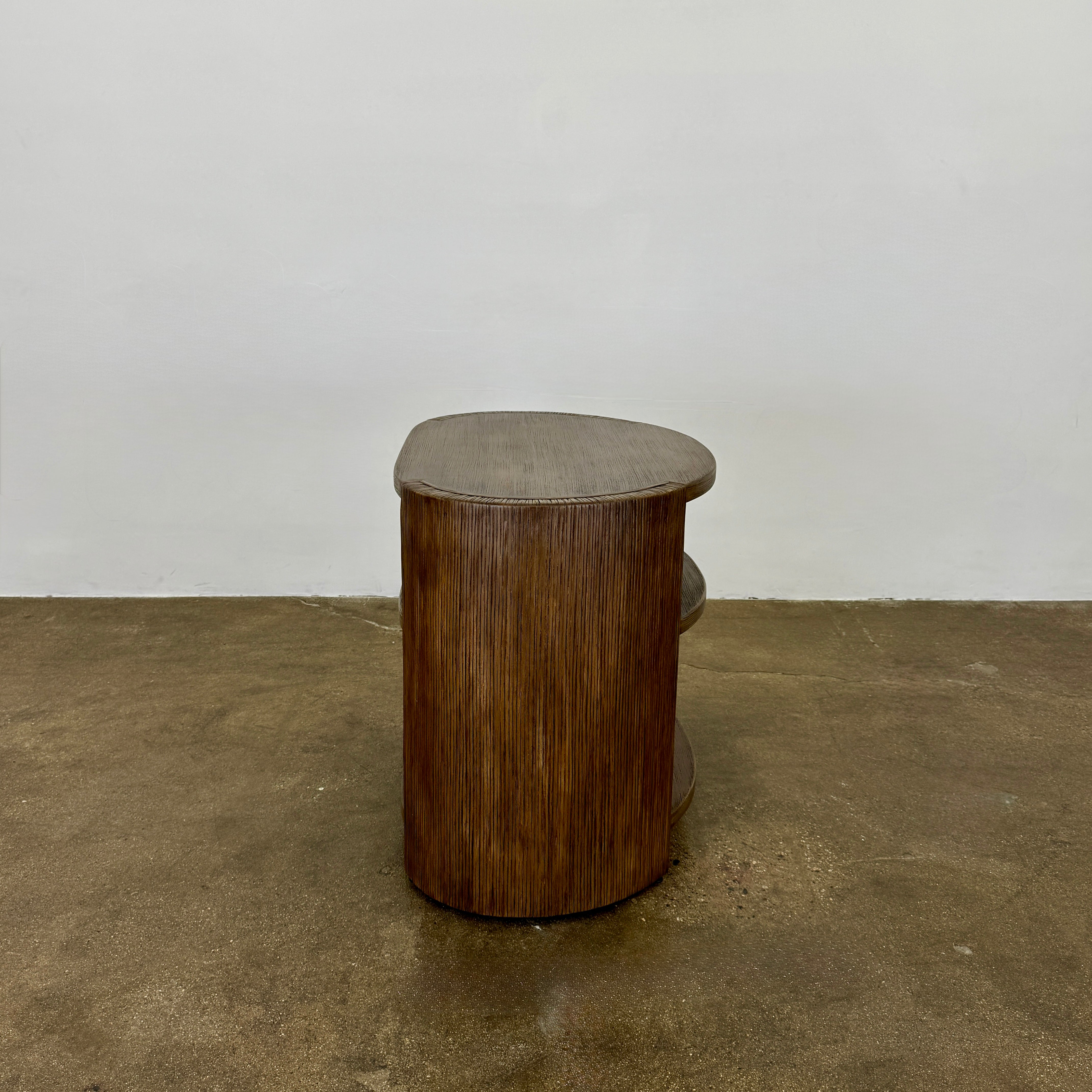 The Palachek Leonardo Side Table, Large, by Palachek features artisan craftsmanship, a dark brown finish, two shelves, and an open minimalist design that suits any contemporary decor against a plain white background.
