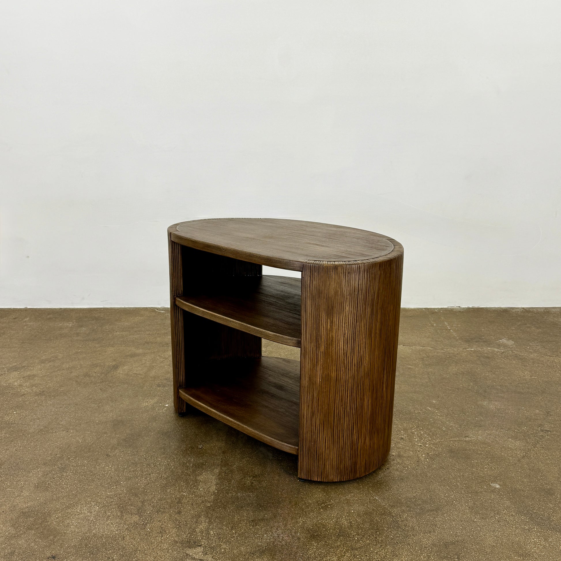 The Palachek Leonardo Side Table, Large, by Palachek features artisan craftsmanship, a dark brown finish, two shelves, and an open minimalist design that suits any contemporary decor against a plain white background.
