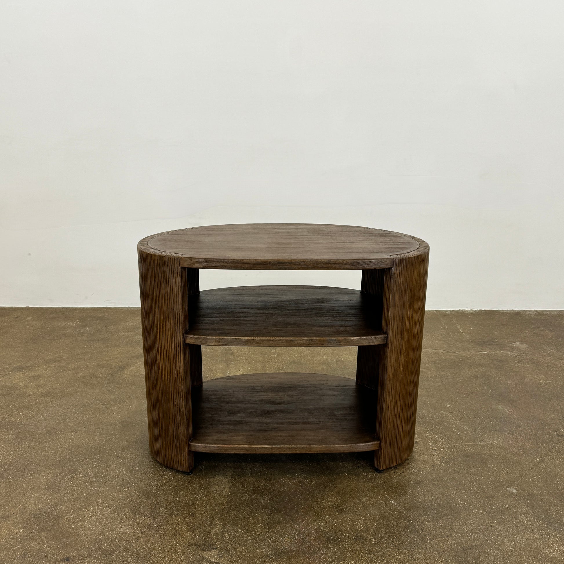 The Palachek Leonardo Side Table, Large, by Palachek features artisan craftsmanship, a dark brown finish, two shelves, and an open minimalist design that suits any contemporary decor against a plain white background.
