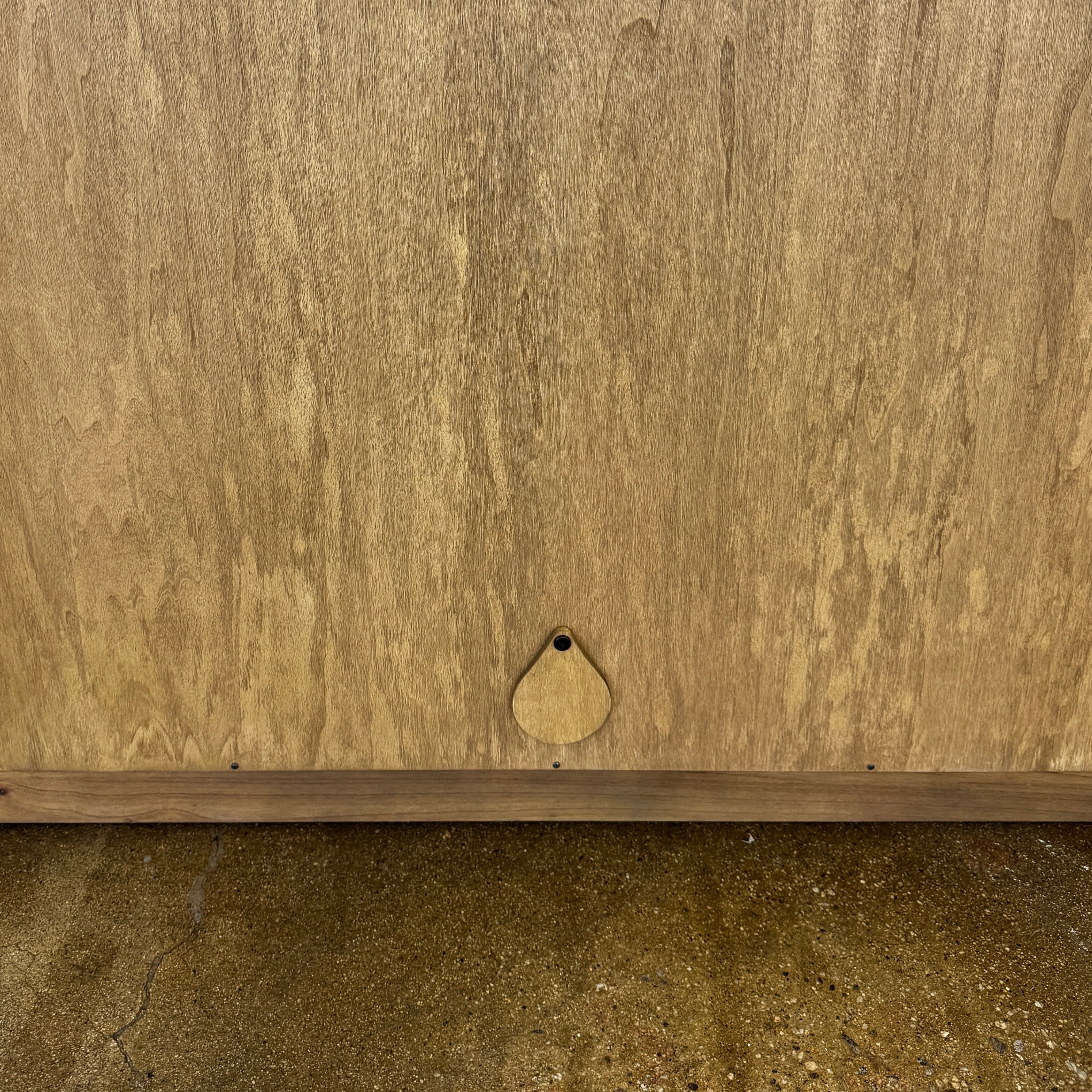 The Boa Small Cabinet by Fourhands features two doors, a gently curved front, light natural wood finish, and round handles, bringing contemporary style to any space.