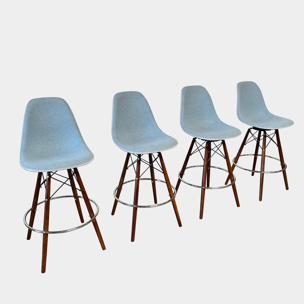 A set of four Modernica Case Study Bar Stool Set bar stools.