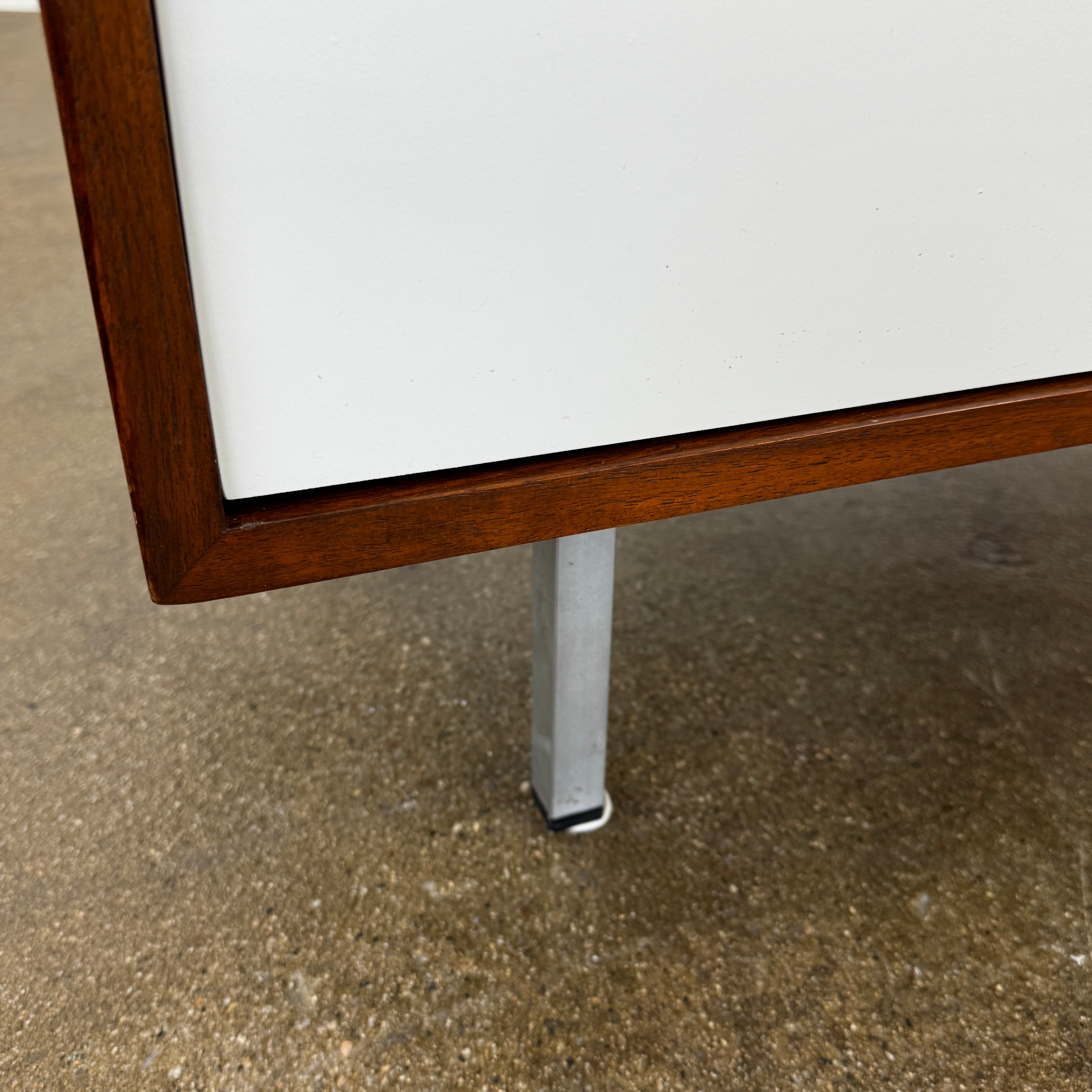 The Knoll Vintage Florence Knoll Office Storage features a dark wood frame, white sliding doors, and metal legs—perfect as a stylish credenza or office storage against a plain white wall.
