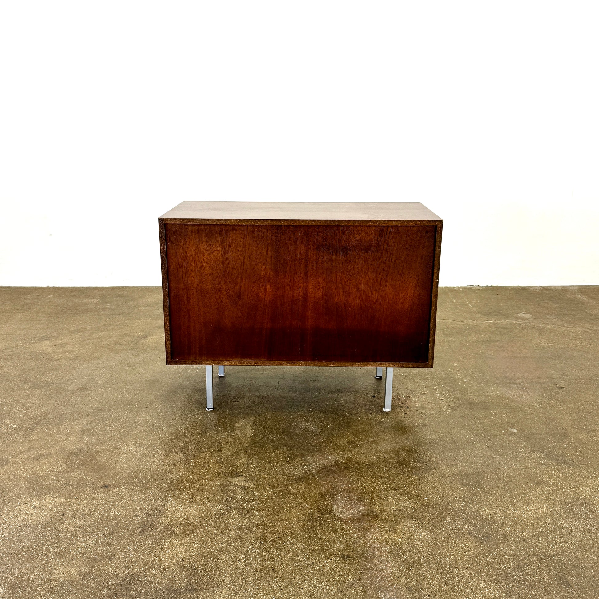 The Knoll Vintage Florence Knoll Office Storage features a dark wood frame, white sliding doors, and metal legs—perfect as a stylish credenza or office storage against a plain white wall.