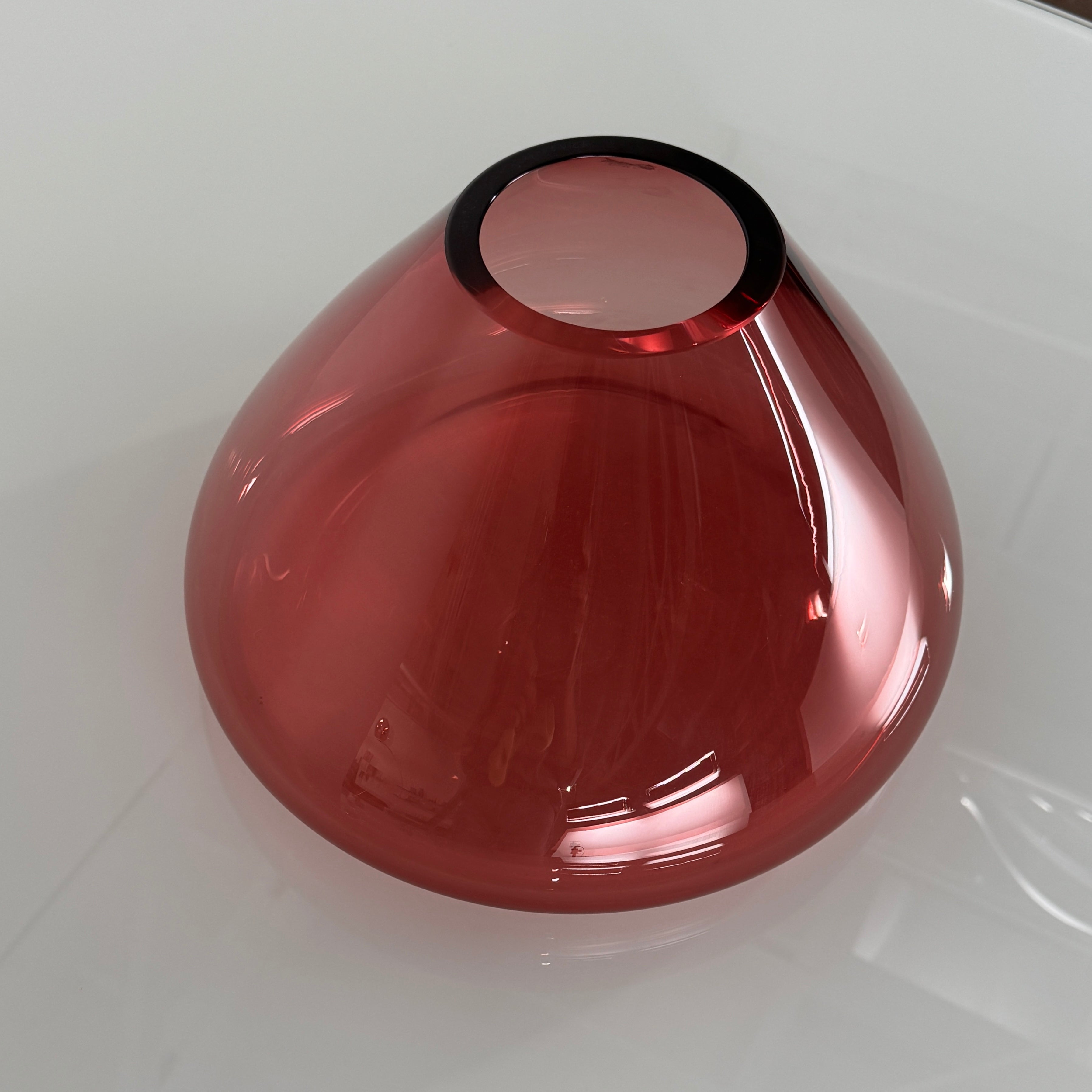 The Arcade Pink Murano Glass Vase by Arcade features pink, hand-blown elegance inspired by Venetian glassmaking, showcased against a plain white background.