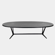 A spacious Maxalto Astrum Dining Table by Maxalto with black oak finish and bronze nickel base is paired with eight evenly arranged dark brown chairs in a minimalist setting.