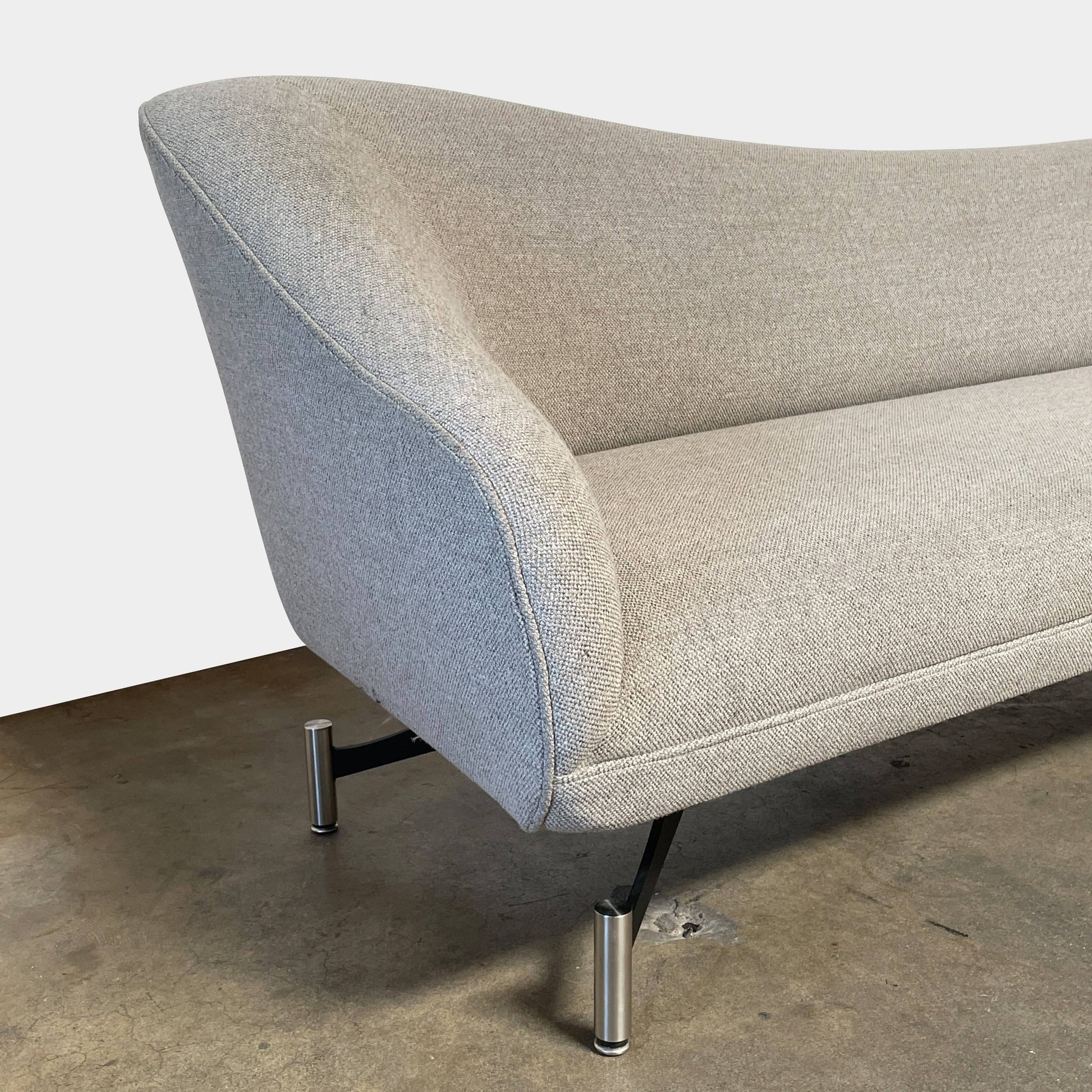 A Kagan Swan L-Shaped Sofa with legs on a white background.