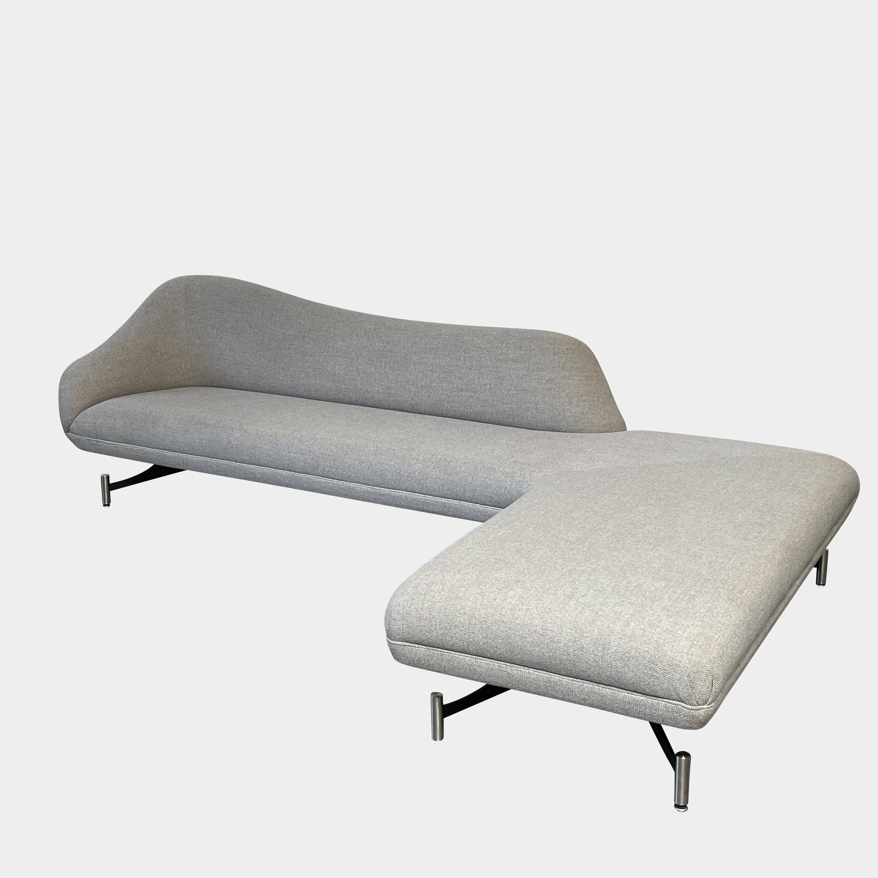 A Kagan Swan L-Shaped Sofa with legs on a white background.