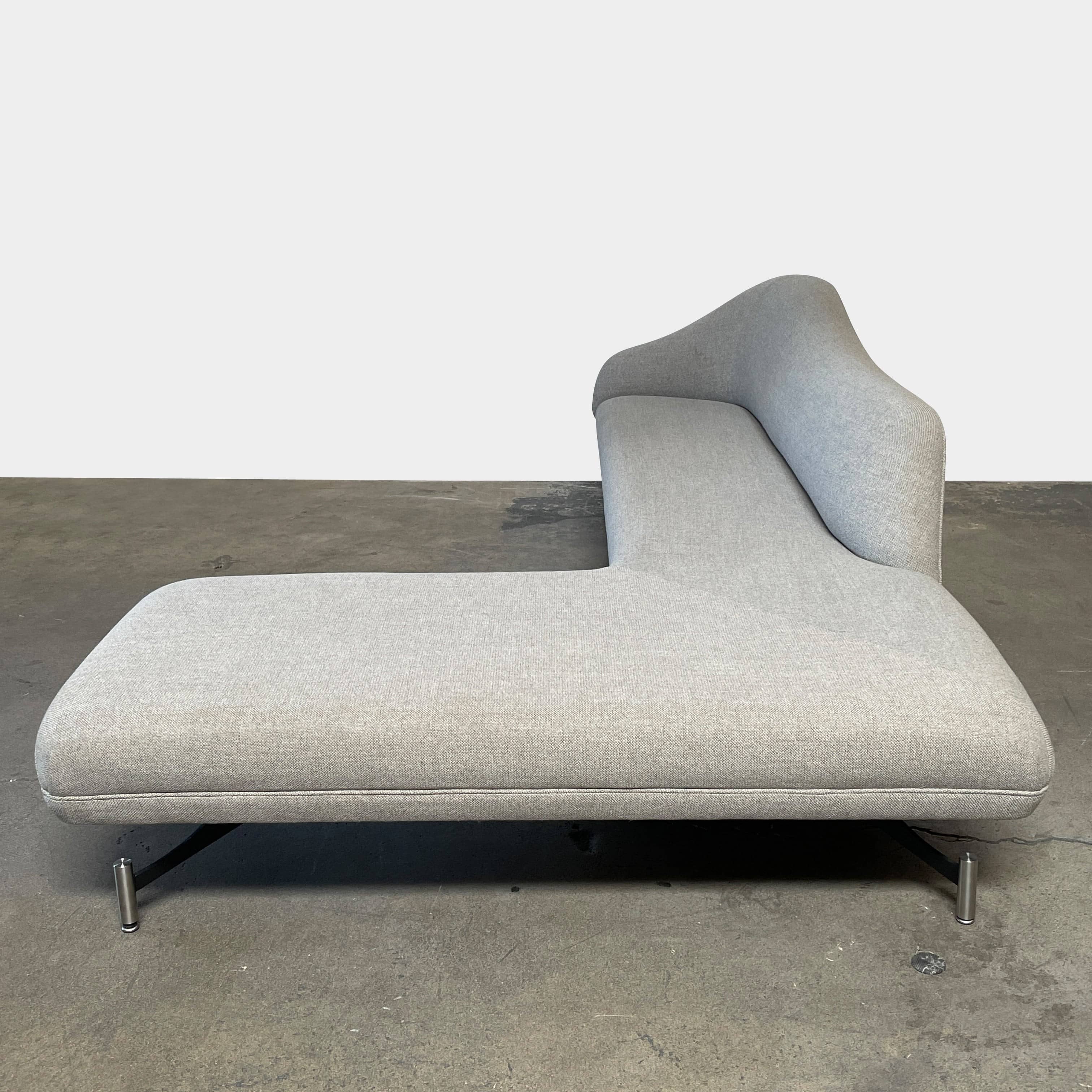 A Kagan Swan L-Shaped Sofa with legs on a white background.