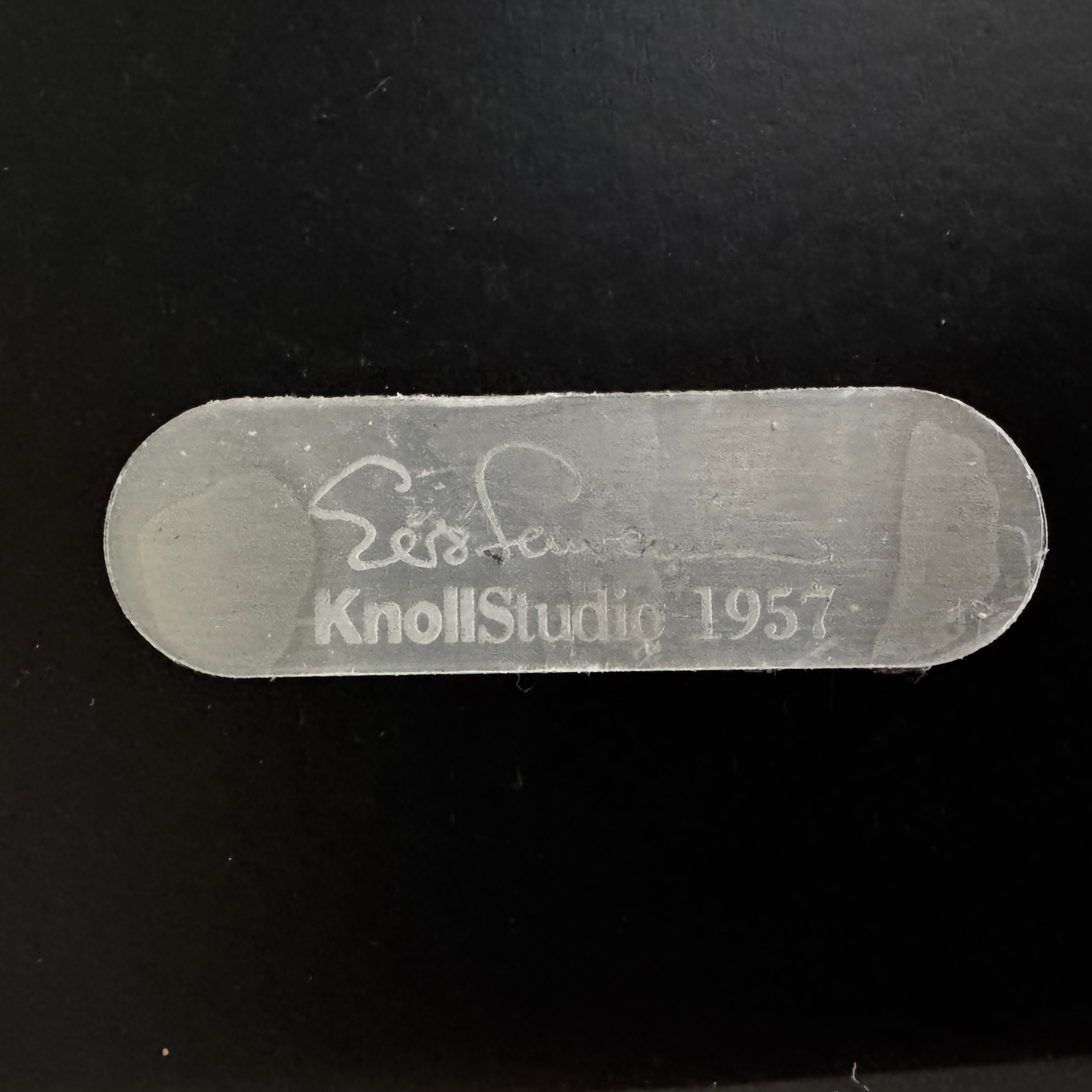 The Knoll Oval Verde Alpi Marble Saarinen Table features a gray marble top and a black pedestal base, inspired by the classic design, set against a plain white background.