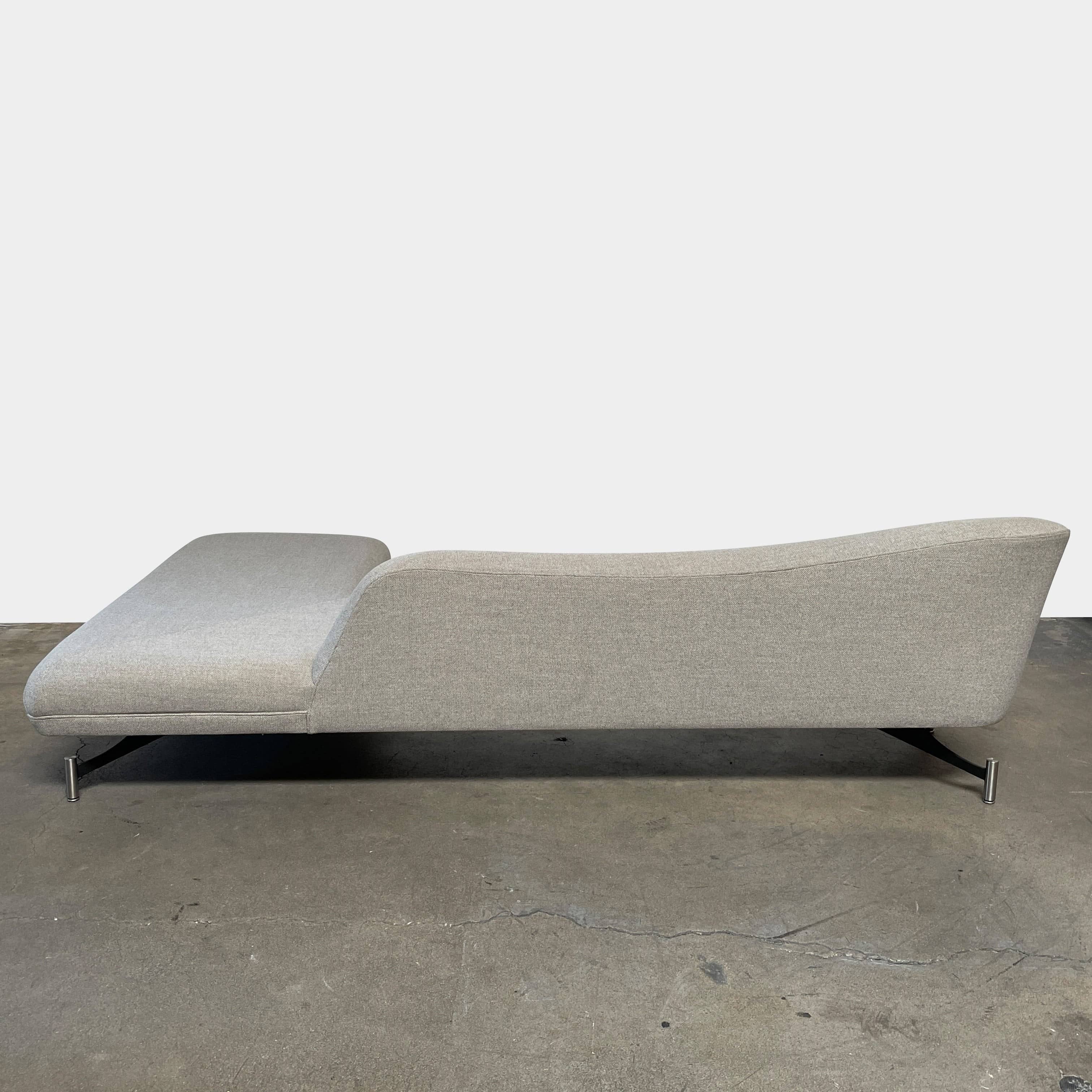 A Kagan Swan L-Shaped Sofa with legs on a white background.