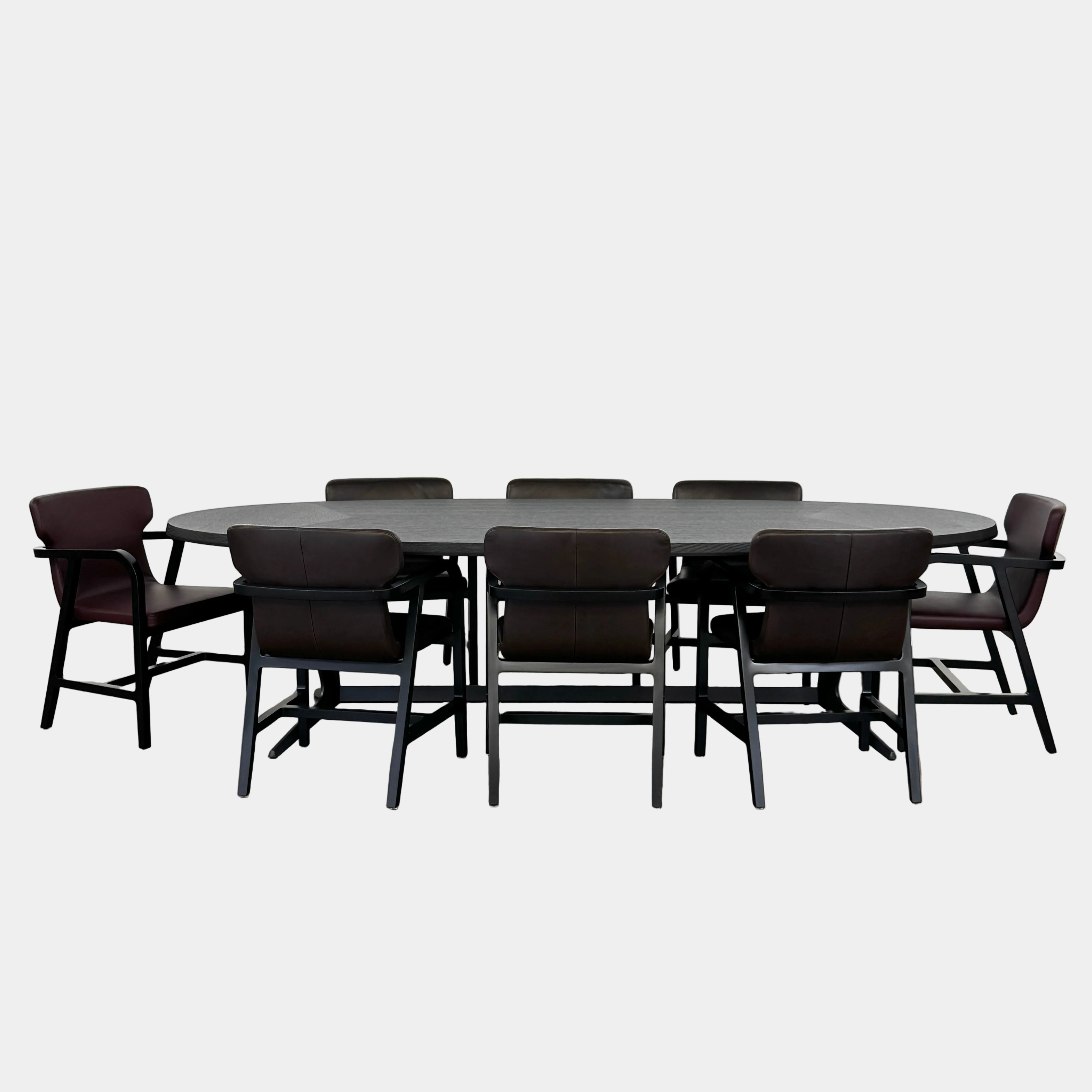 The Maxalto Astrum Dining Table with eight Fulgens Armchairs by Maxalto, arranged evenly in dark brown upholstery, creates a refined luxury dining set displayed on a plain white background.