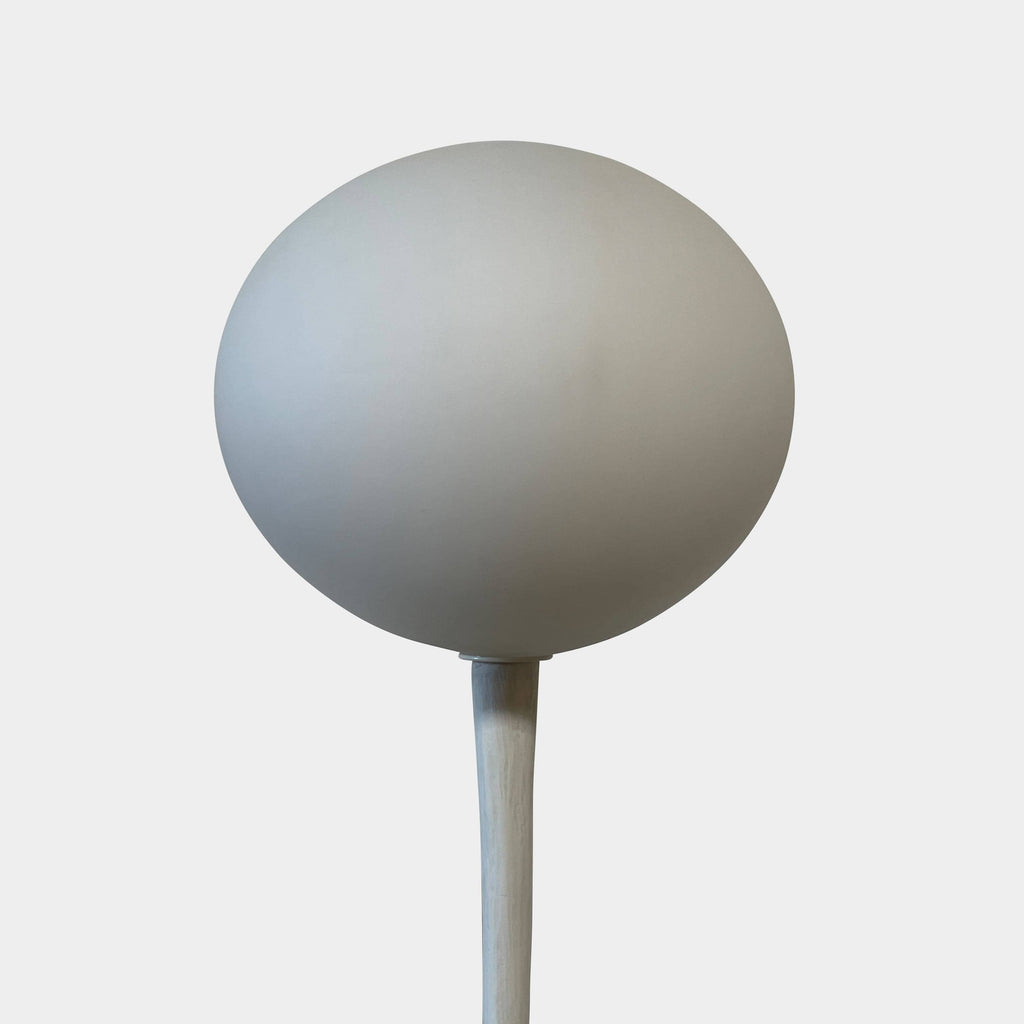 A Ralph Pucci Kukui Floor Light Sculpture with a ball on it.