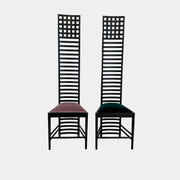 A pair of Cassina 292 Hill House Chairs by Charles R. Mackintosh, with black slatted frames—one featuring a burgundy seat cushion, the other dark green—showcasing Cassina's modernist design against a plain white background.