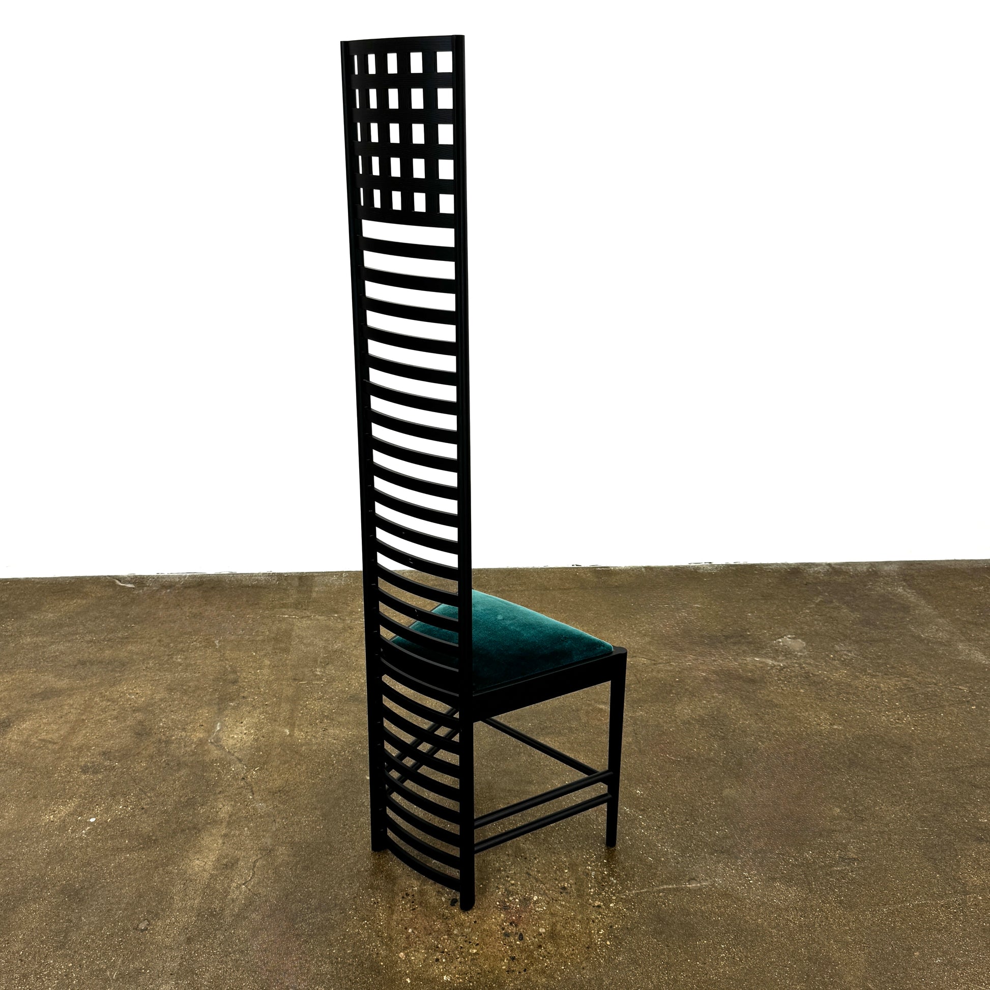 A pair of Cassina 292 Hill House Chairs by Charles R. Mackintosh, with black slatted frames—one featuring a burgundy seat cushion, the other dark green—showcasing Cassina's modernist design against a plain white background.