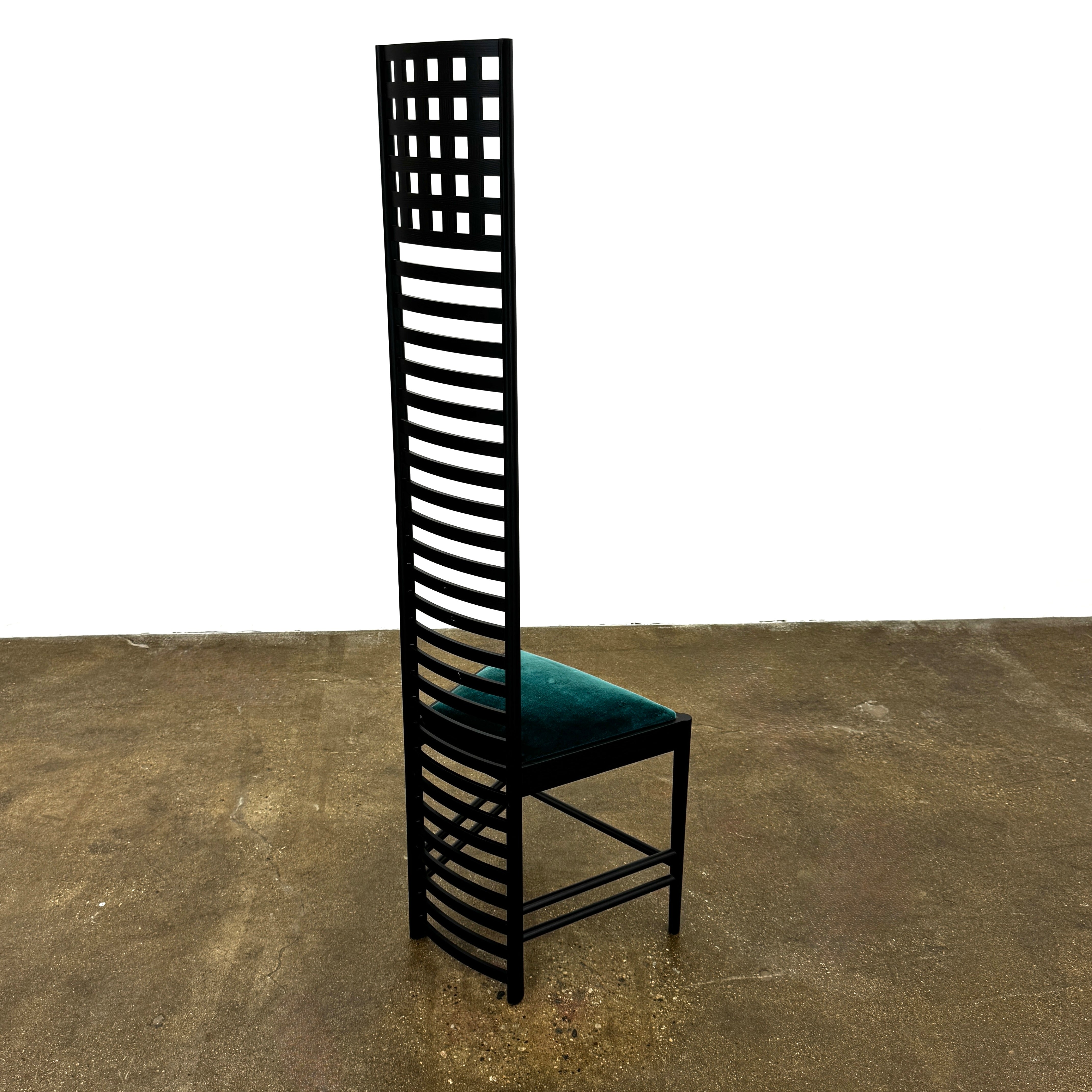 A pair of Cassina 292 Hill House Chairs by Charles R. Mackintosh, with black slatted frames—one featuring a burgundy seat cushion, the other dark green—showcasing Cassina's modernist design against a plain white background.