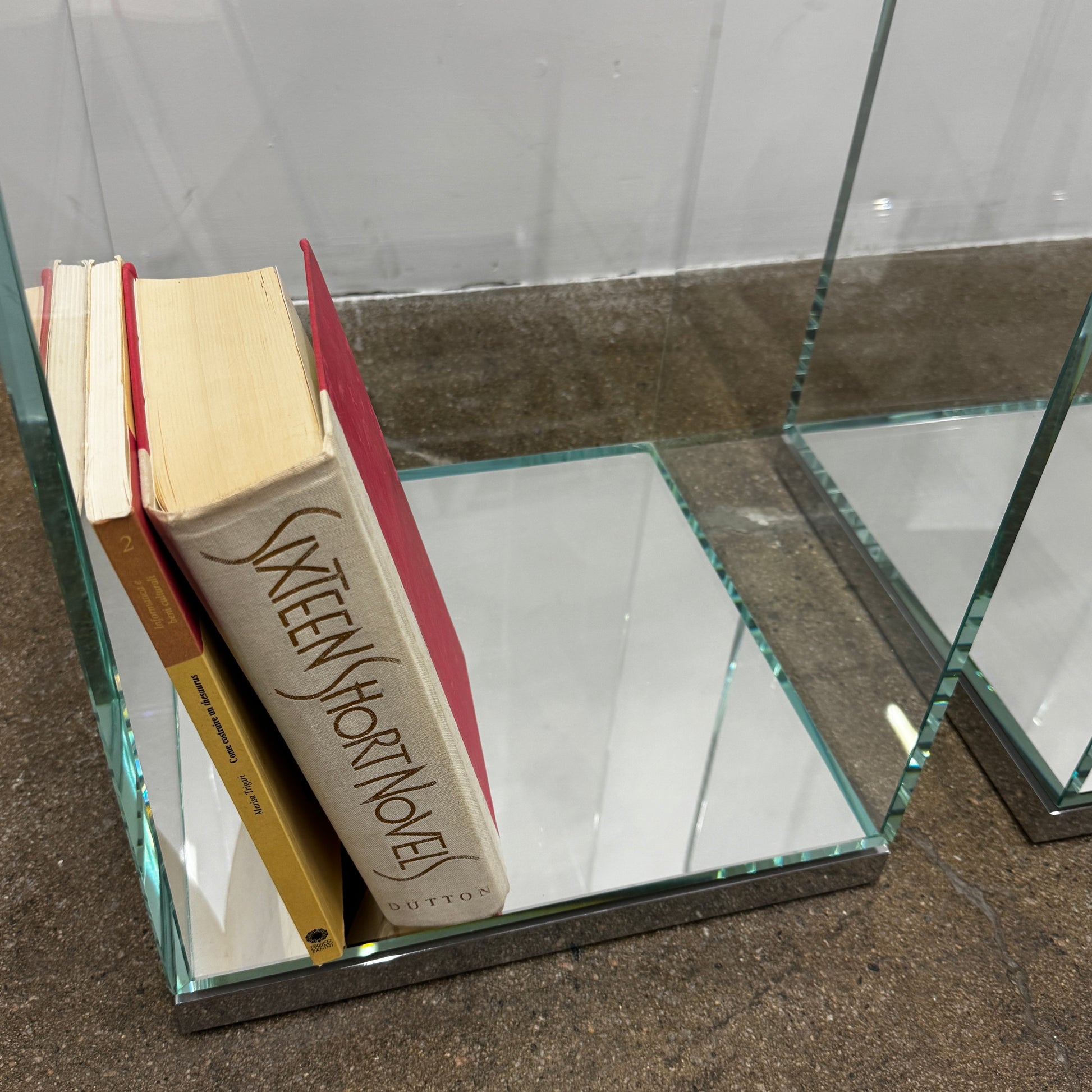 A clear rectangular glass display case with a metal base, inspired by the Cassina Volage side table Philippe Starck from Cassina, shown against a plain white background.