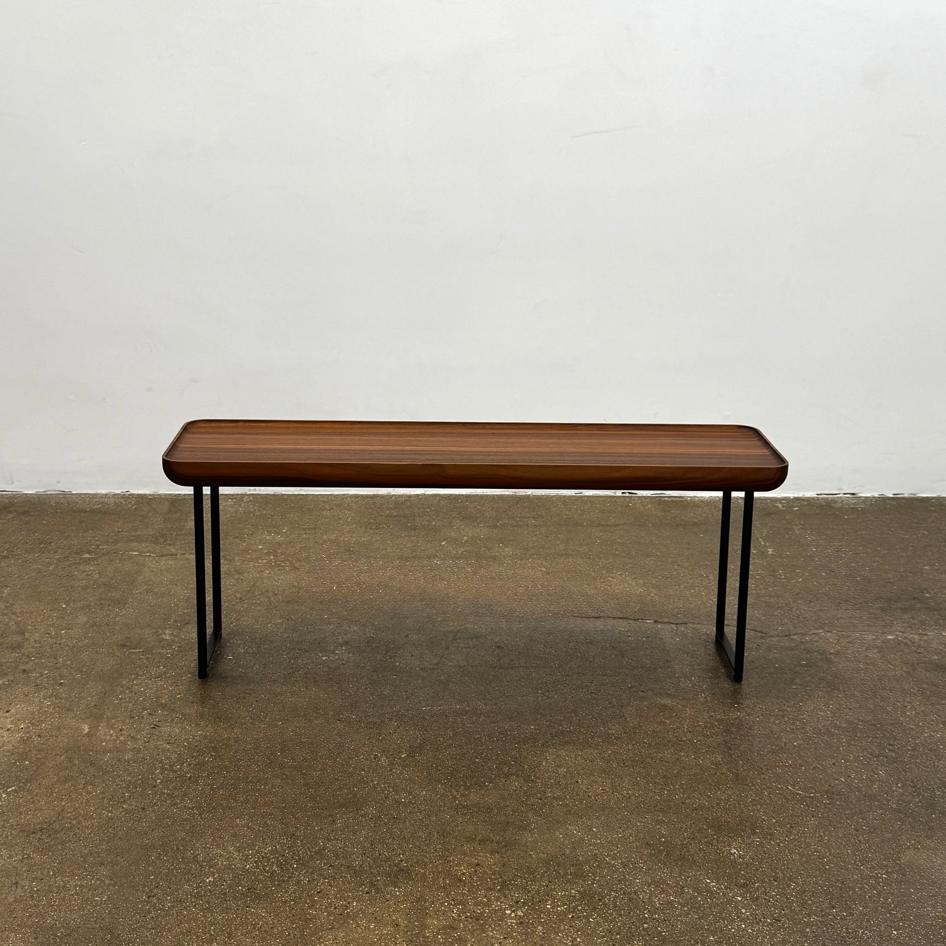 The Cassina Torei Occasional Table Natural Ash by Cassina features rounded edges and sleek black metal legs, shown on a plain white background.