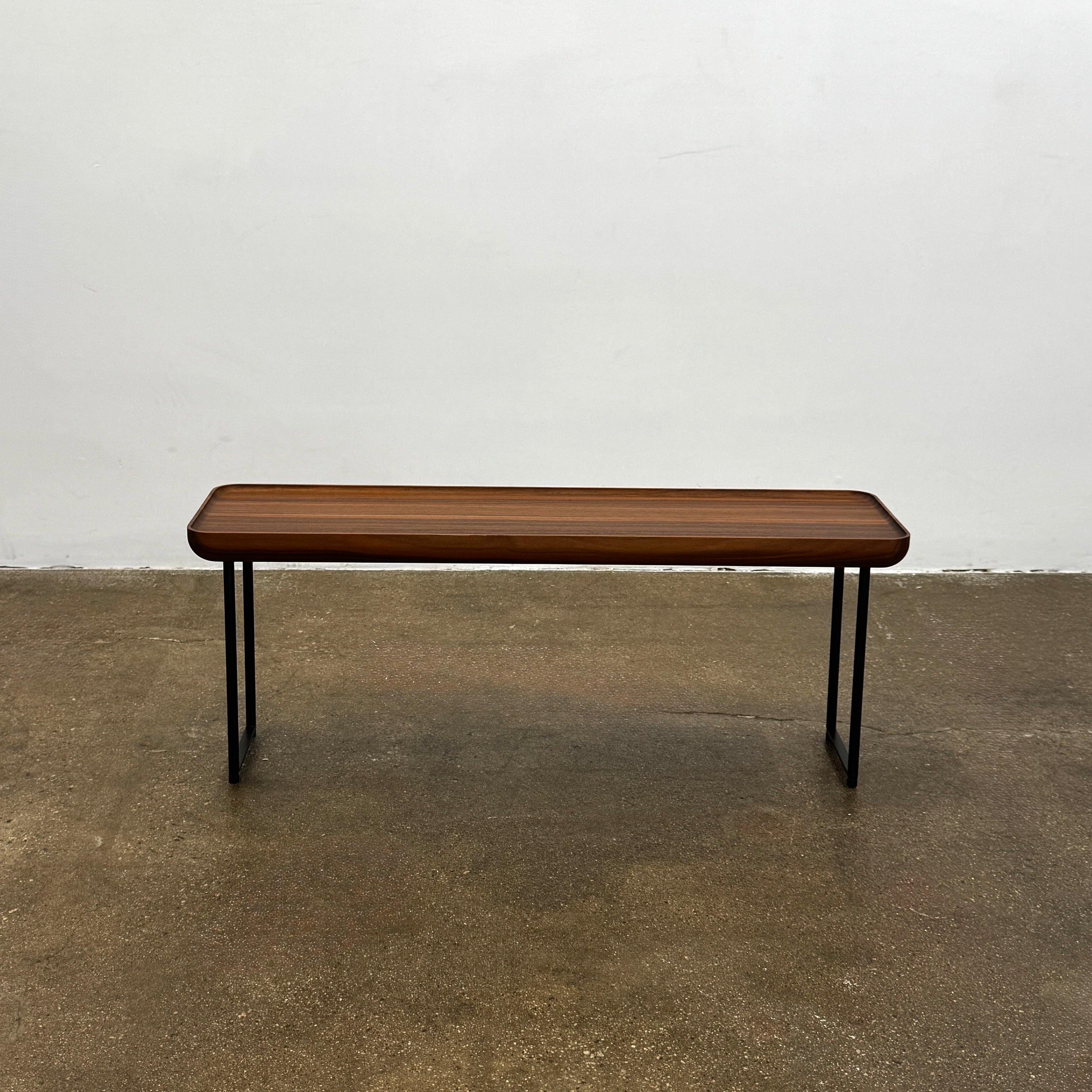 The Cassina Torei Occasional Table Natural Ash by Cassina features rounded edges and sleek black metal legs, shown on a plain white background.
