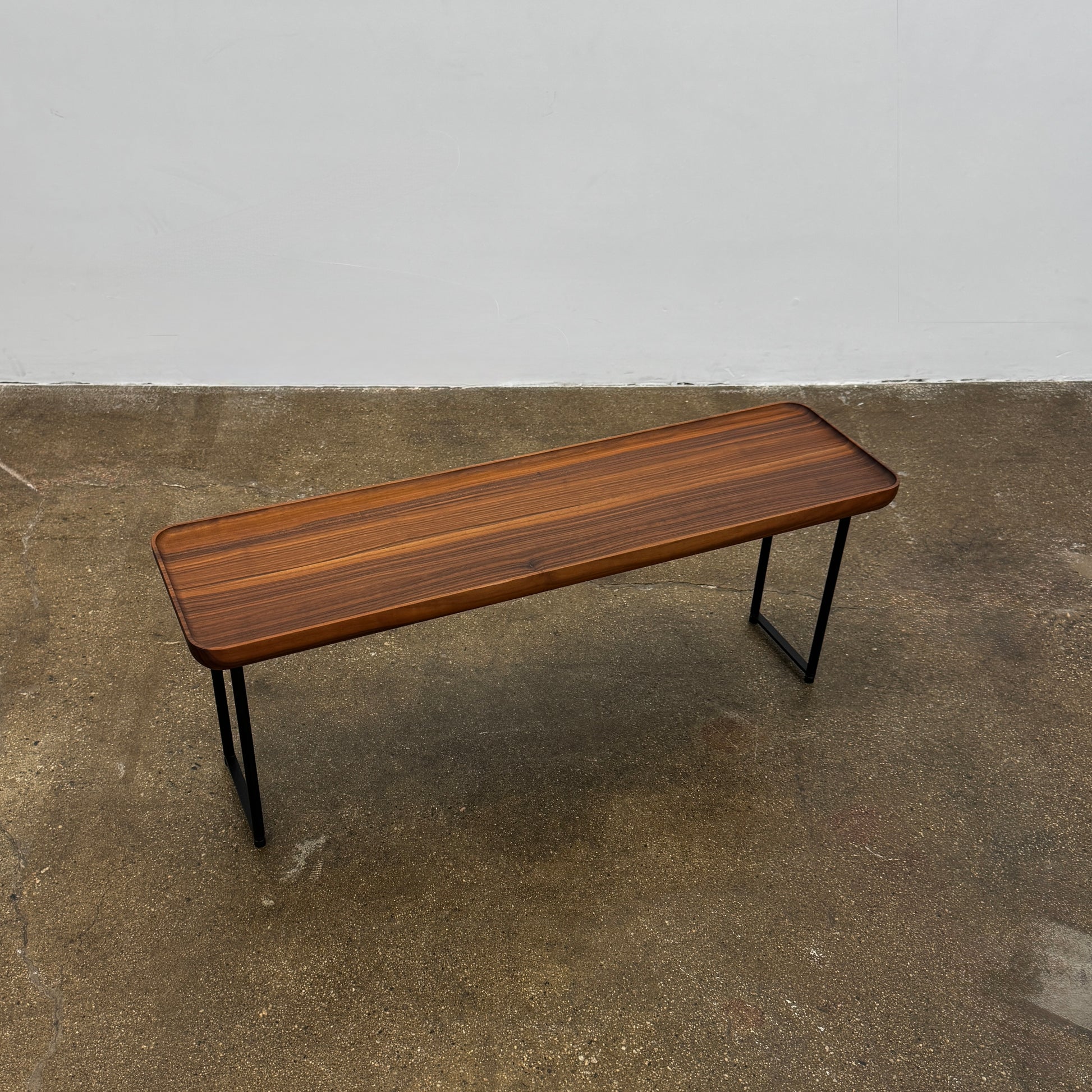 The Cassina Torei Occasional Table Natural Ash by Cassina features rounded edges and sleek black metal legs, shown on a plain white background.