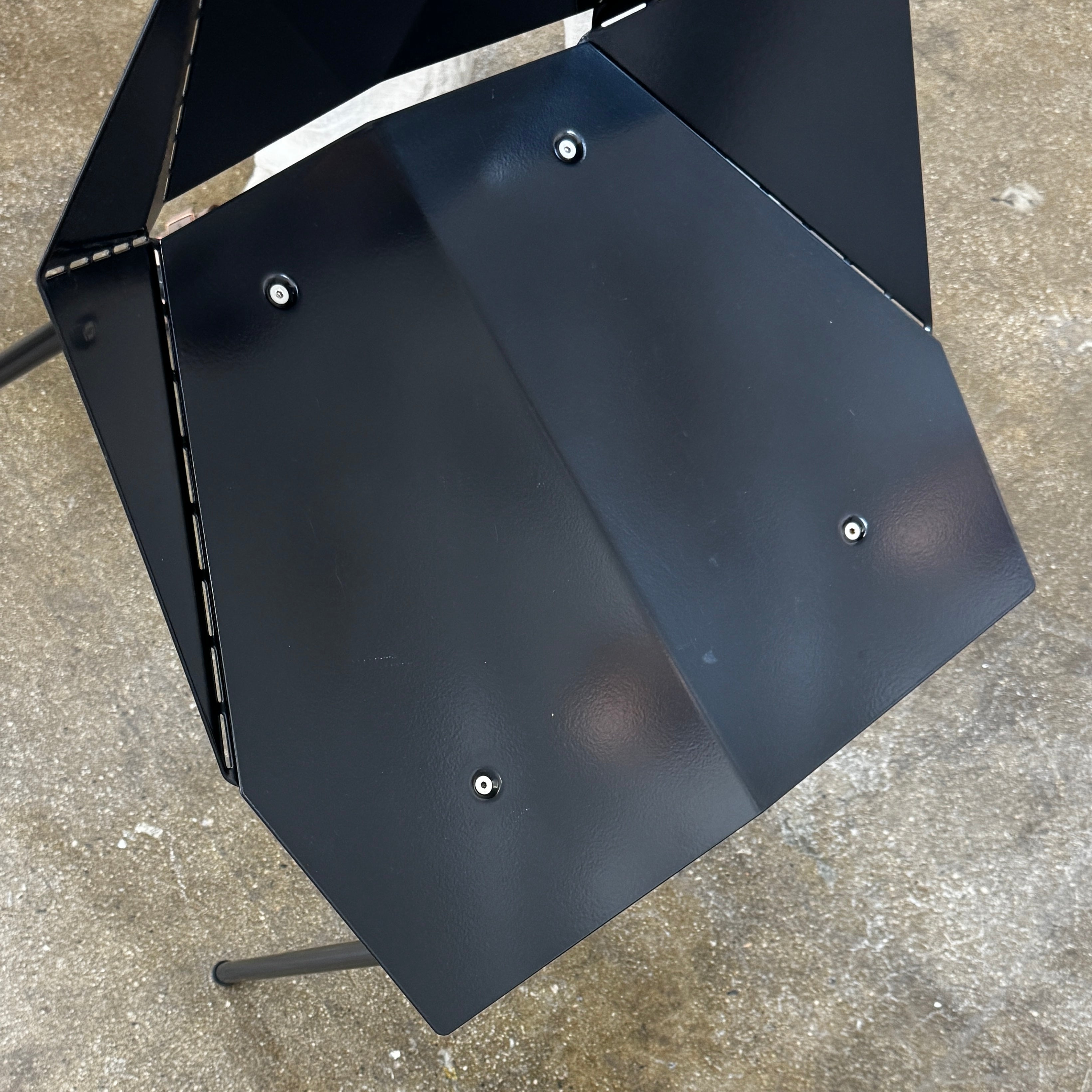 The Blu Dot “Real Good Chair” by Blu Dot is a black, angular steel chair with four metal legs and a powder-coated finish, shown against a plain white background.